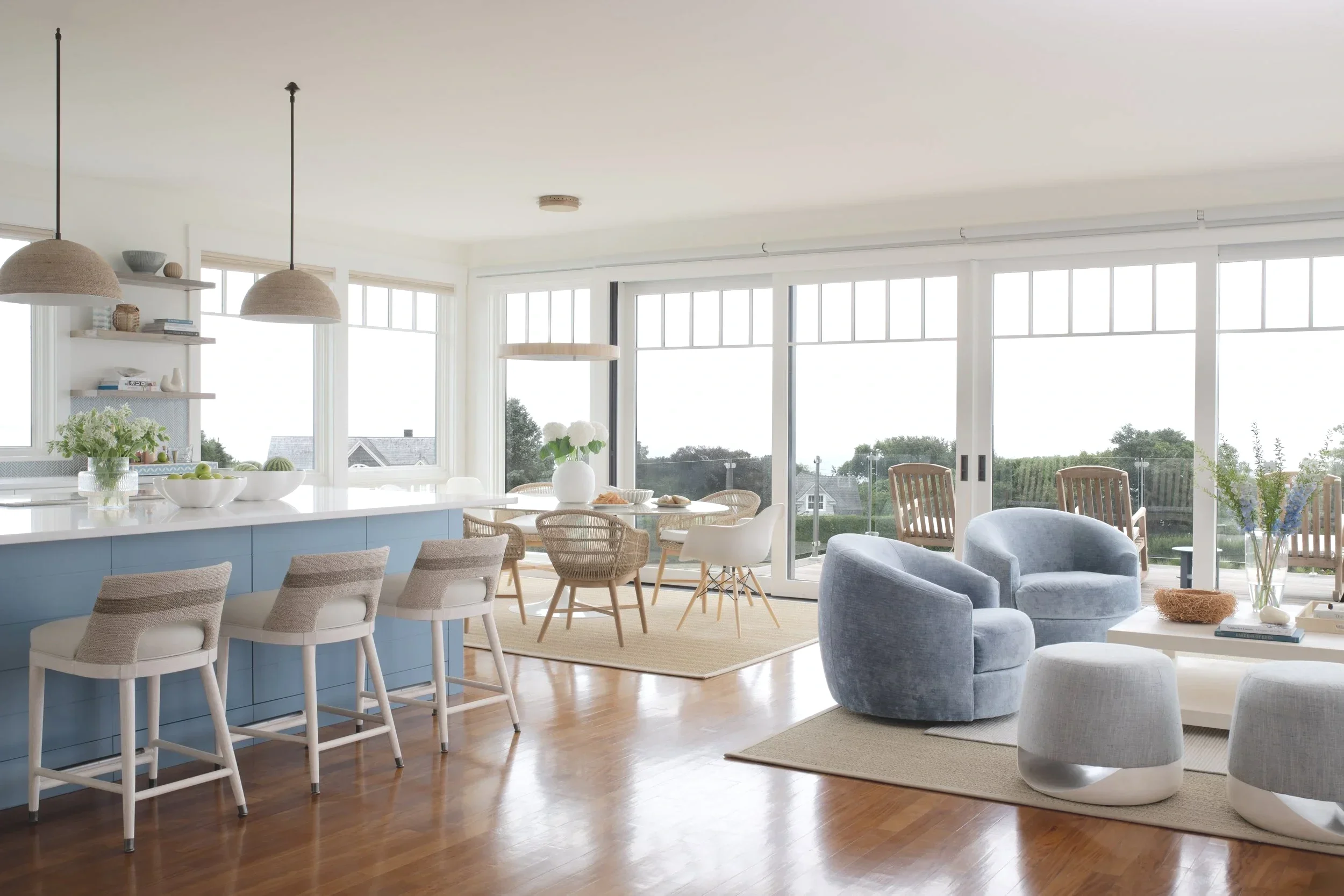 Rhode Island coastal home featuring a renovated kitchen, living room, and dining room with timeless furnishings and layered textures.