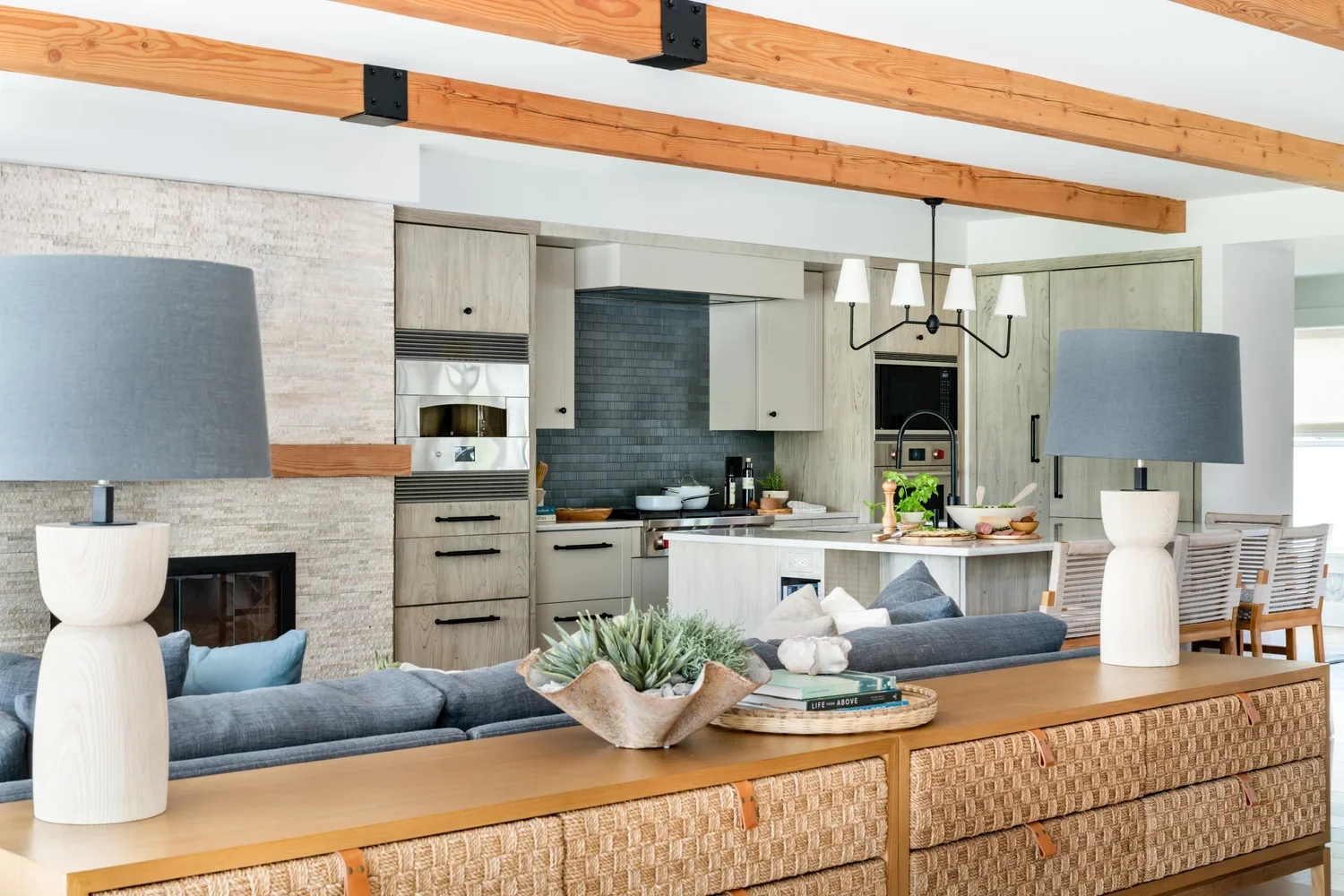 Norwell, Massachusetts pool house interior design featuring an indoor saltwater pool, mini kitchen, and hearth in a custom guest house.