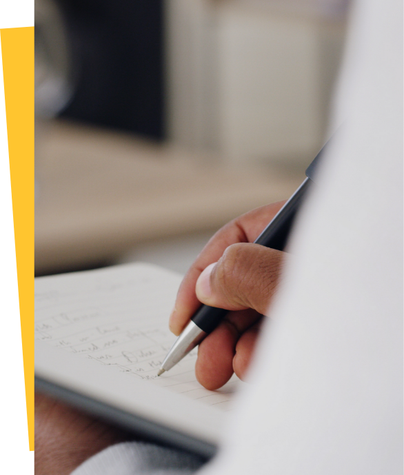 Someone writing in a notepad