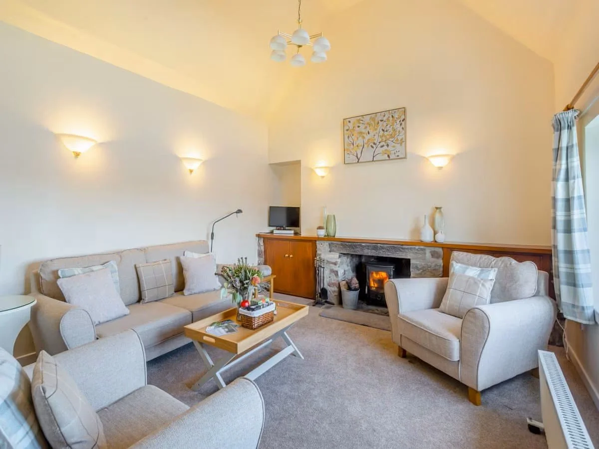 Bunloit Farmhouse - Living room with fire.jpeg