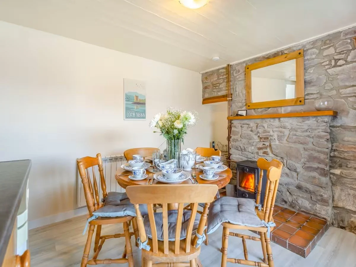 Bunloit Farmhouse - dining area with wood burning stove.jpeg