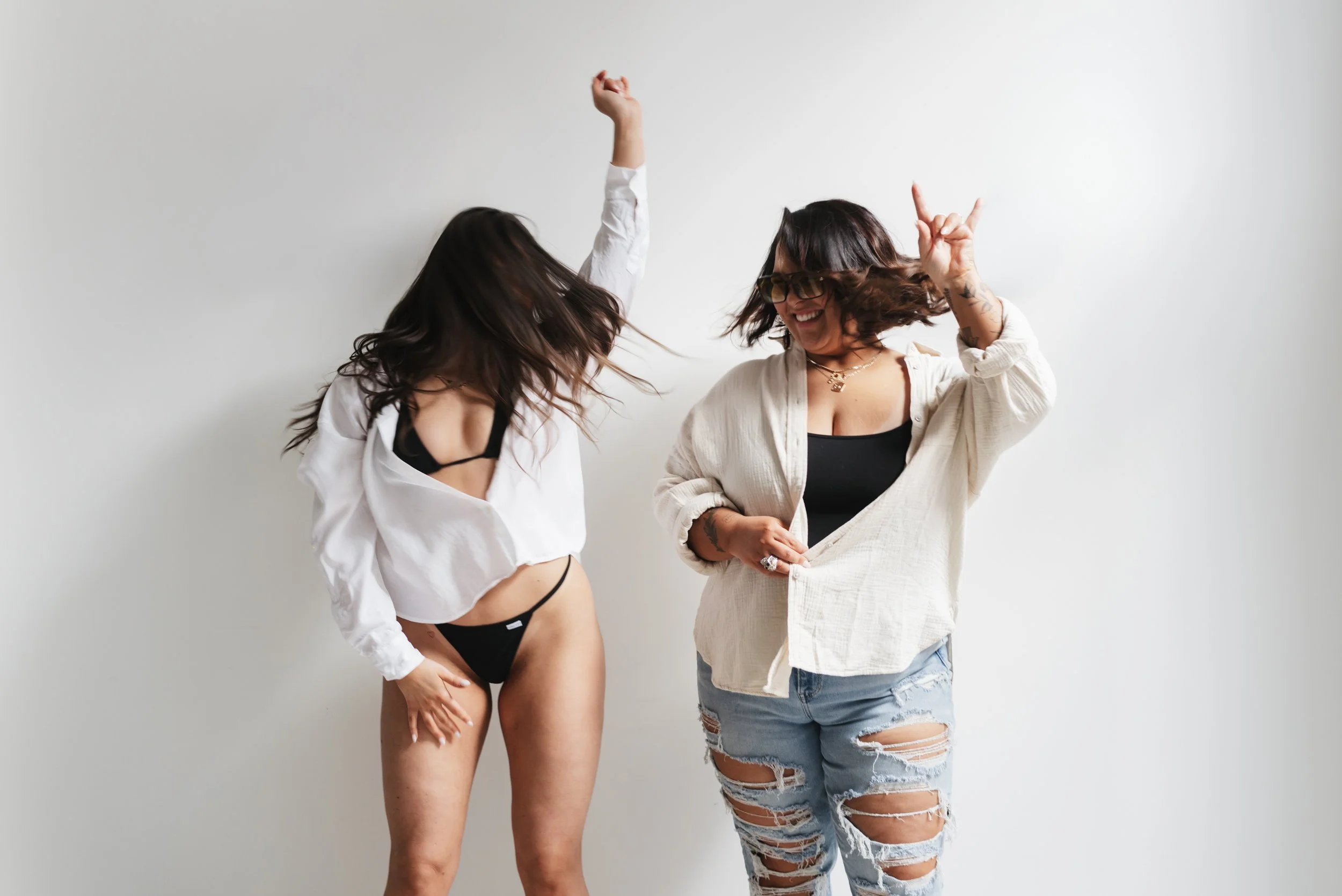 Two women having fun and shaking their hair around.