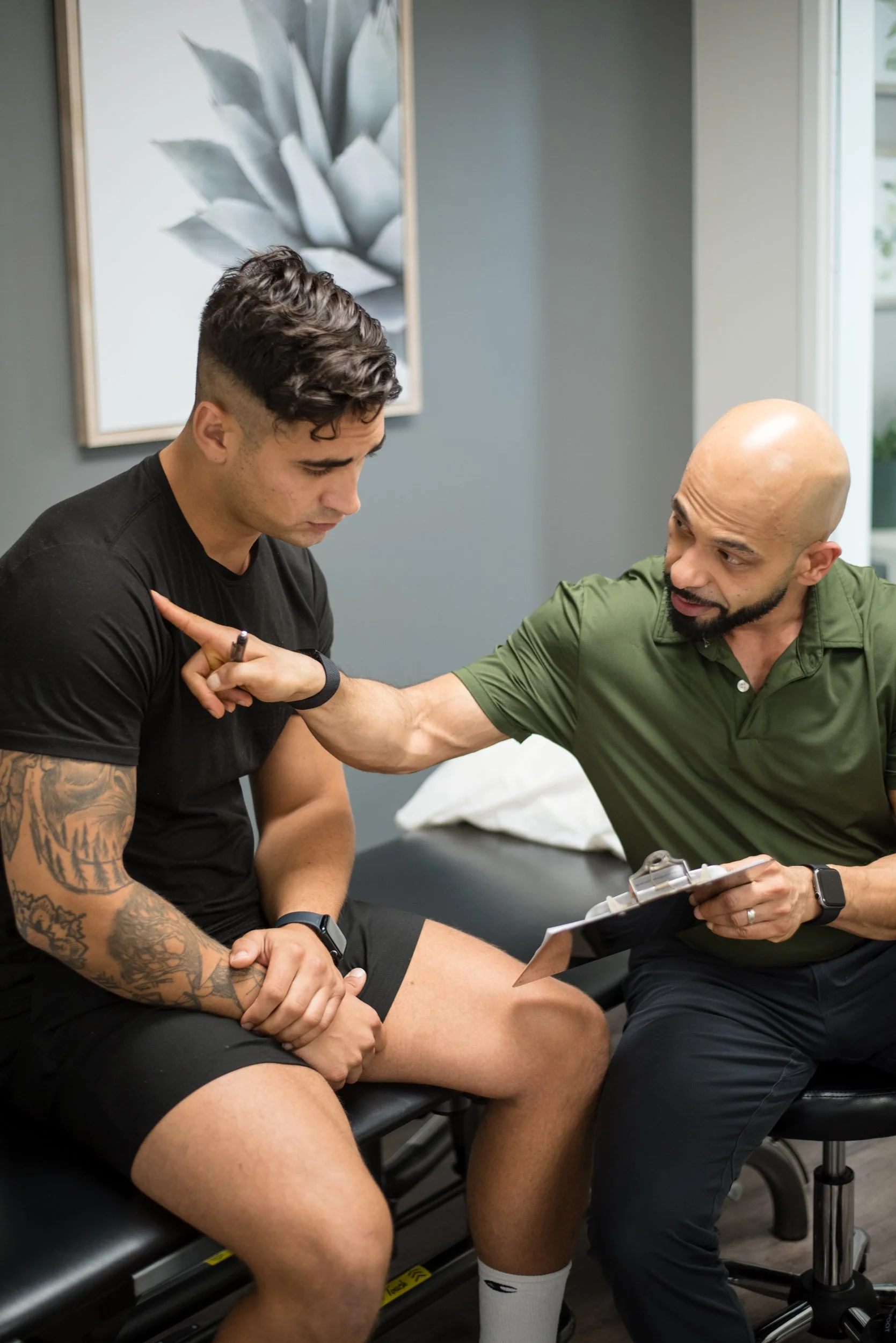 Chiropractor doing a consultation with a client.