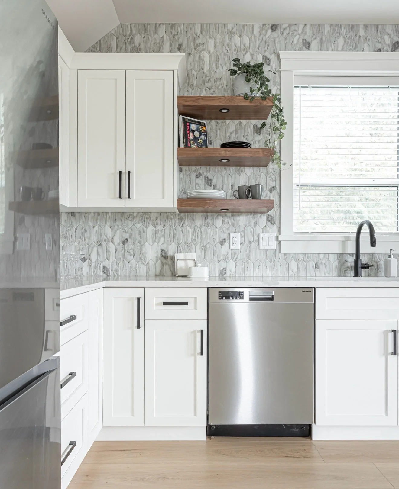 Coach house kitchen, did you say? Small spaces call for functionality without forgoing design. The goal was to keep this space bright, warm, and inviting &mdash; I think we did just that. Stone countertops, stainless appliances, recessed lighting and