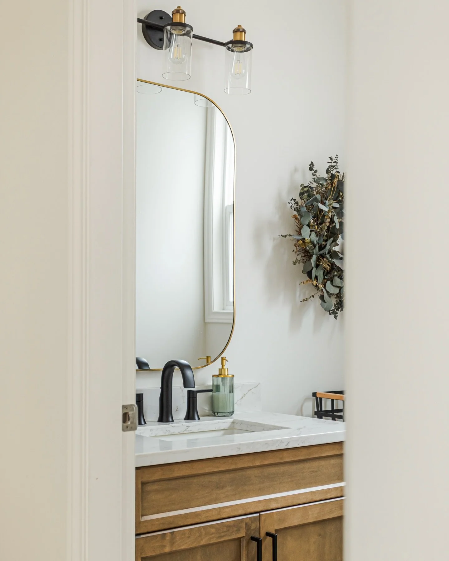 This powder room is all about warmth and simplicity &mdash; creamy walls, walnut vanity, and earthy tones that bring a natural, serene vibe. Perfectly balanced and effortlessly chic.

Project: Bastin Residence
Design: @shayeinteriors
Contractor: @arc