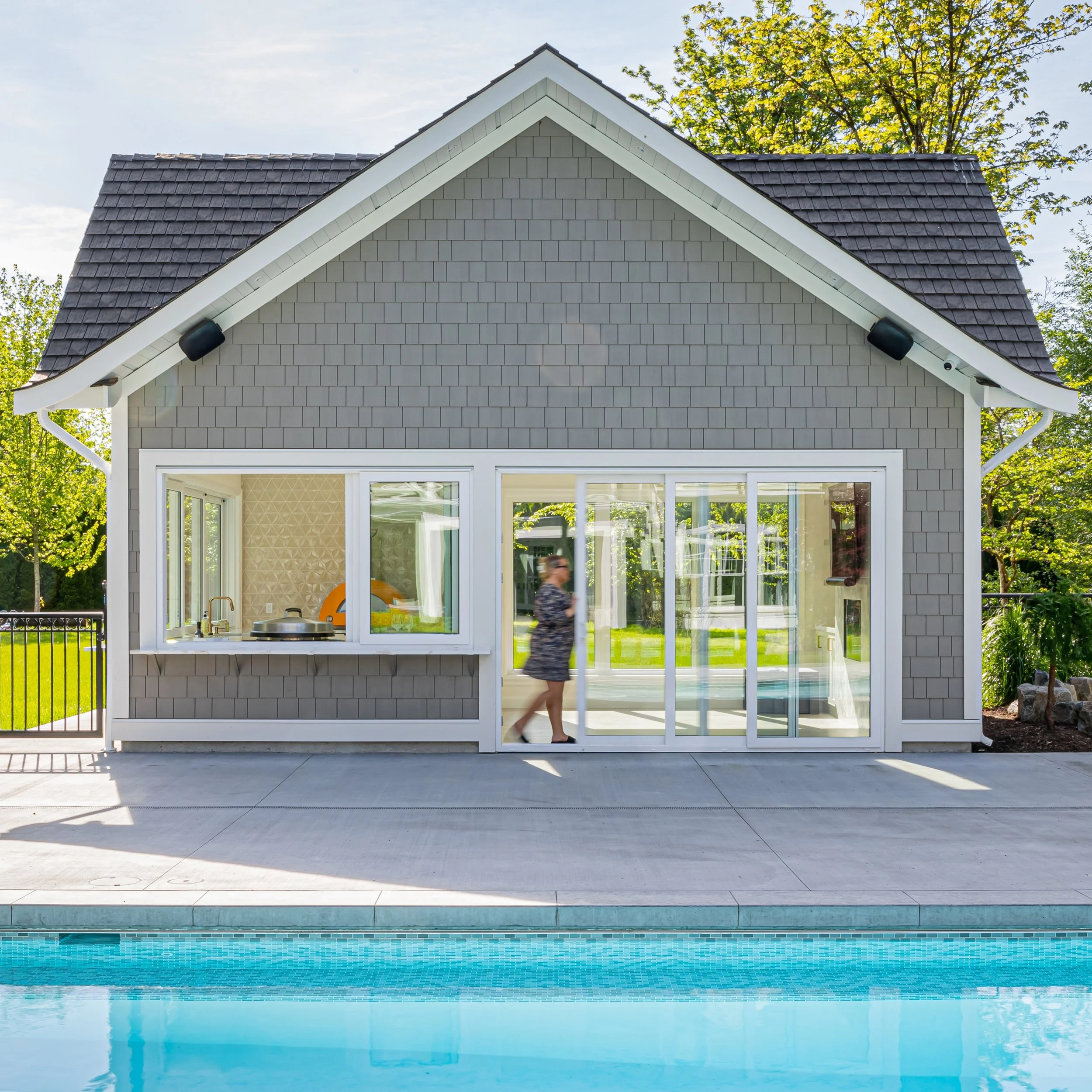 Interior design doesn&rsquo;t just belong in the home. 

Sunshine pours through the large windows, collapsible doors and bar top giving this pool house a beautiful backdrop. 

Wood-tone tile flooring to match the main home but eliminate any damage fr