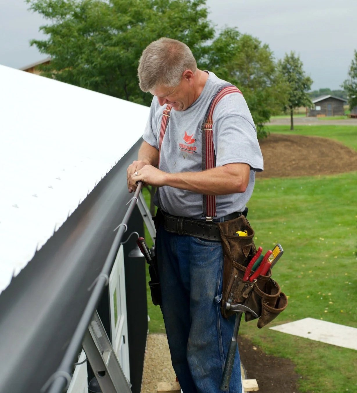 Gutter installer working on a half-round gutter