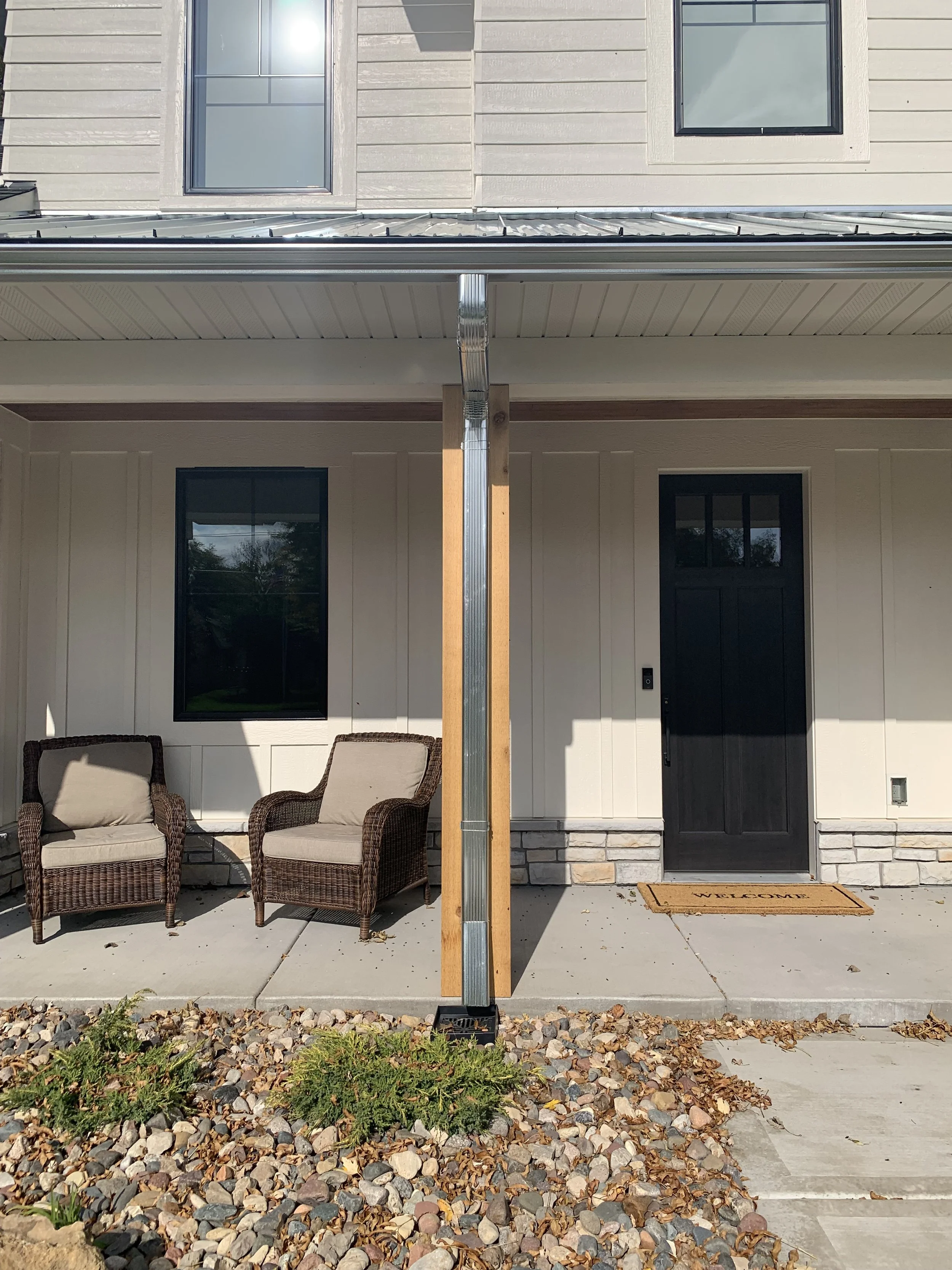 FoxGuard Gutter Covers on a galvanized gutter with a galvanized downspout on a front porch post