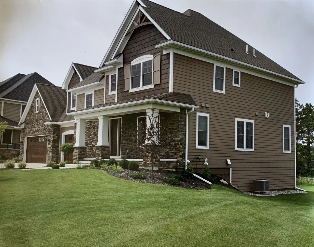 Big house with gutters and downspouts