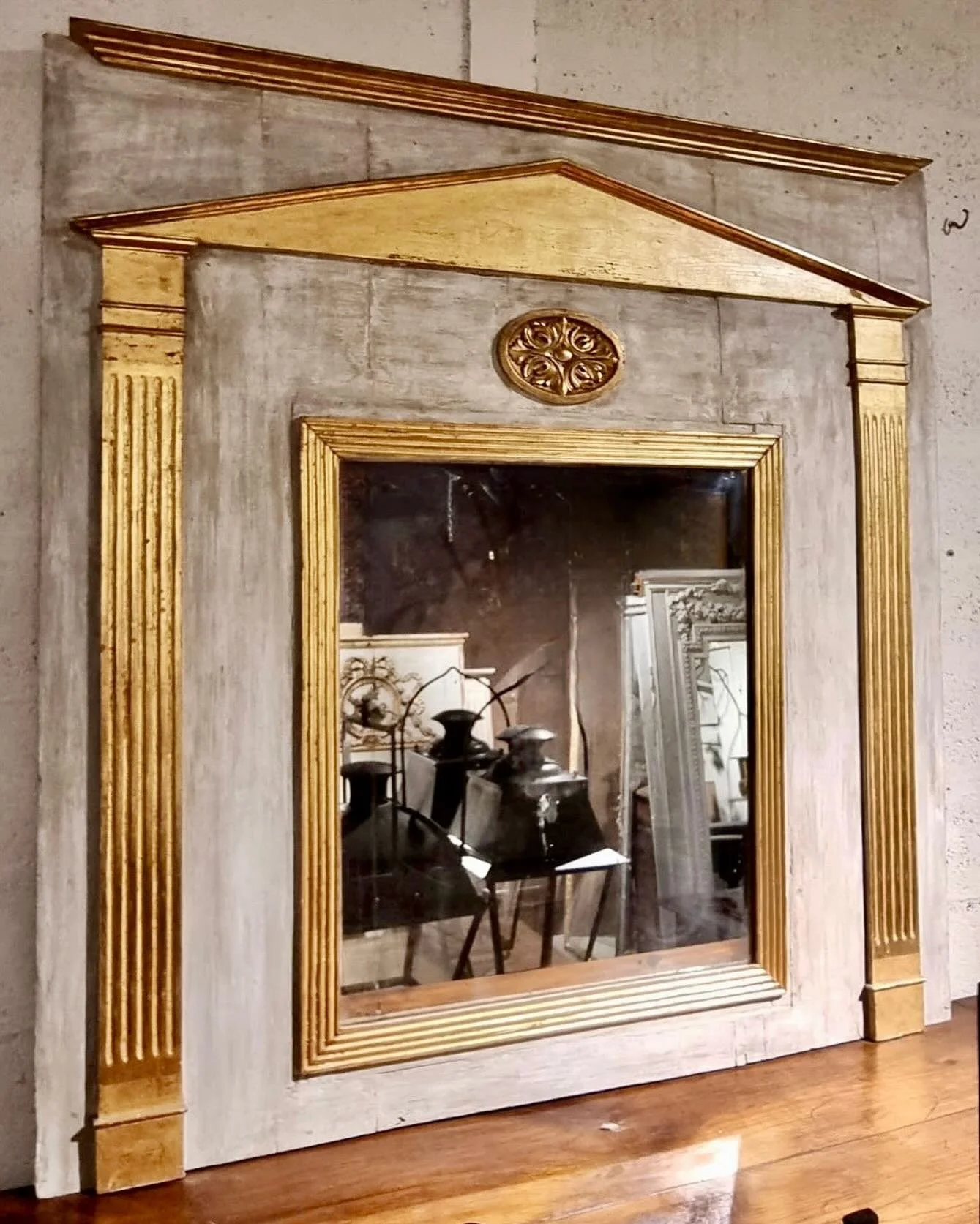 En Route&mdash;Antique Directoire Period Reeded and Gold Gilt Wood Trumeau Mirror. French, c.1795. Dimensions are 56.2W x 57.5H. Discover our extensive collection of one-of-a-kind, hand-selected European Antiques and Curated Decor. Find more details 