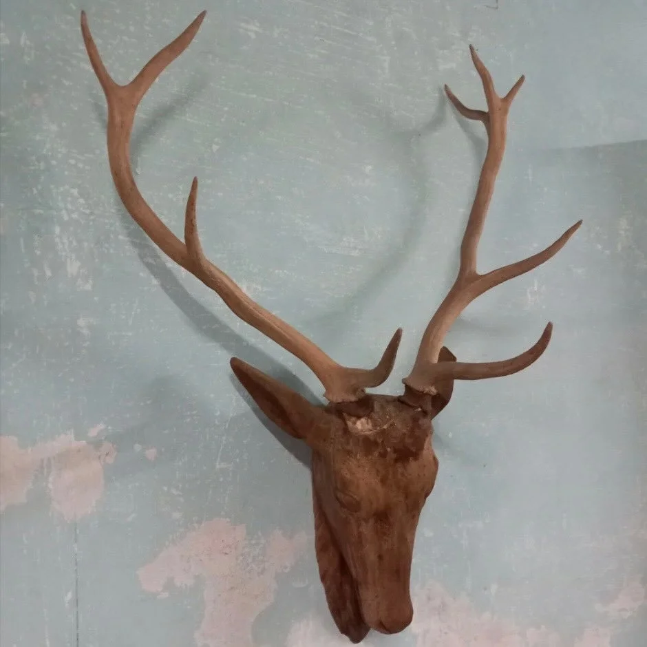 Anxiously awaiting for this handsome fellow to arrive in our next container! Antique Hand Carved Wooden Deer Head Trophy Mount with Natural Antlers. French, c.1820. Dimensions are 26.3W x 34.6H. Discover our extensive collection of one-of-a-kind, han