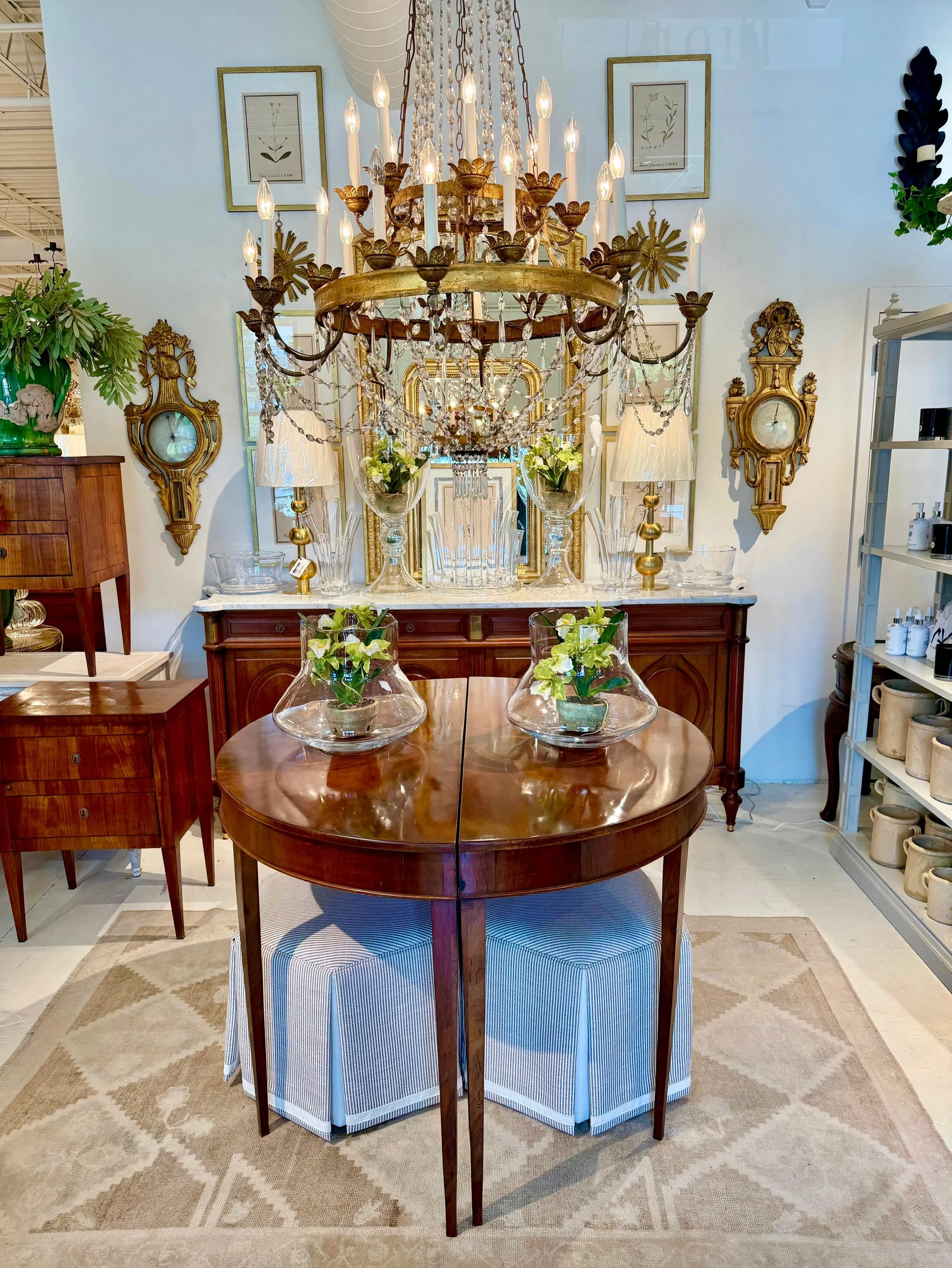 A beautiful pair of Antique Louis XVI-Style Walnut Demilune Tables with Ash Inlay. French, c.1850. Dimensions are 48.5W x 23.75D x 34.5H. Discover our extensive collection of one-of-a-kind, hand-selected European Antiques and Curated Decor. Find more