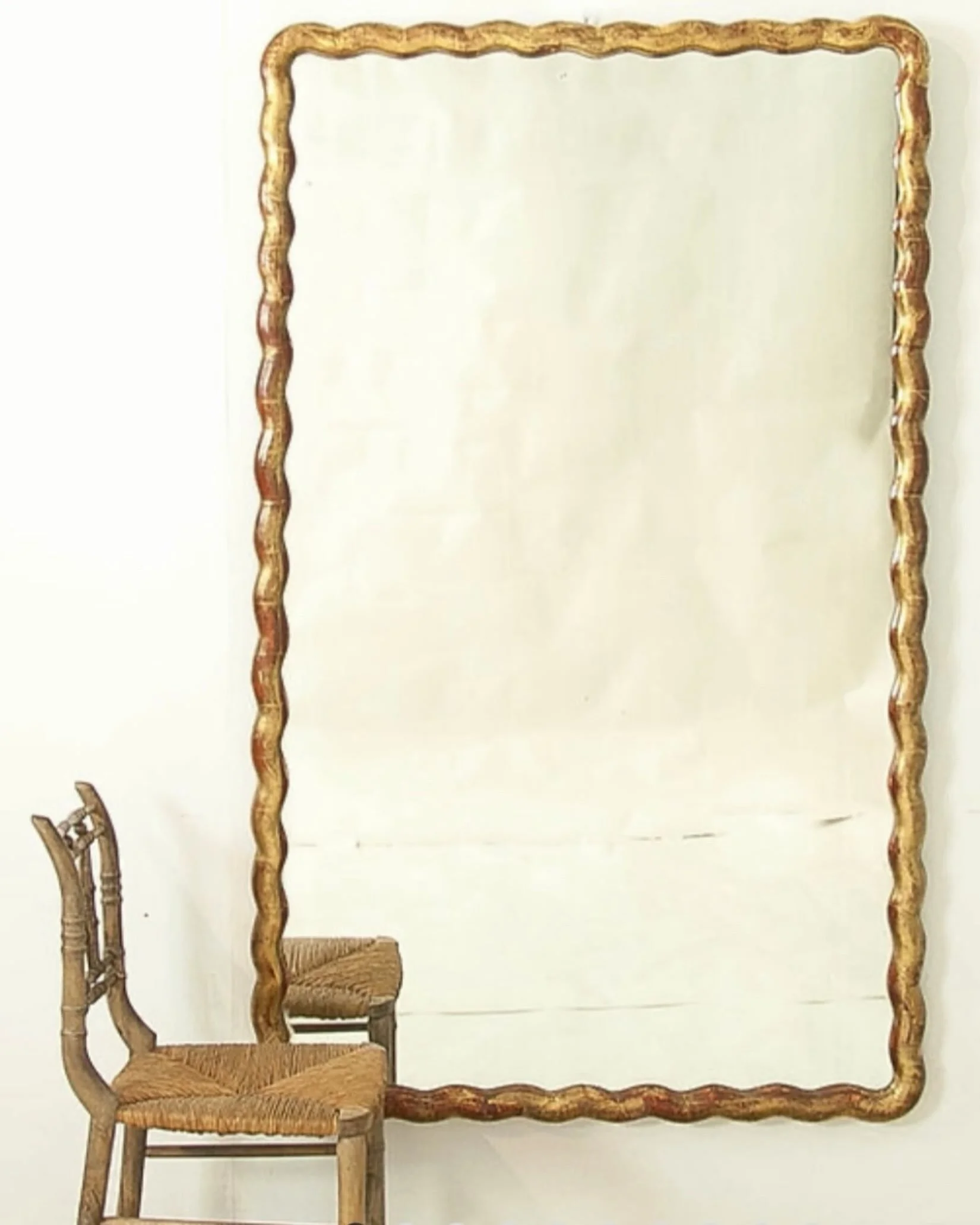 One of the most stunning mirrors in the shoppe right now! An Antique Directoire Period Gilt Wood Scalloped Mirror. French, c.1795. Dimensions are 40.75W x 67H. A stunning piece of antiquity. Discover our extensive collection of one-of-a-kind, hand-se