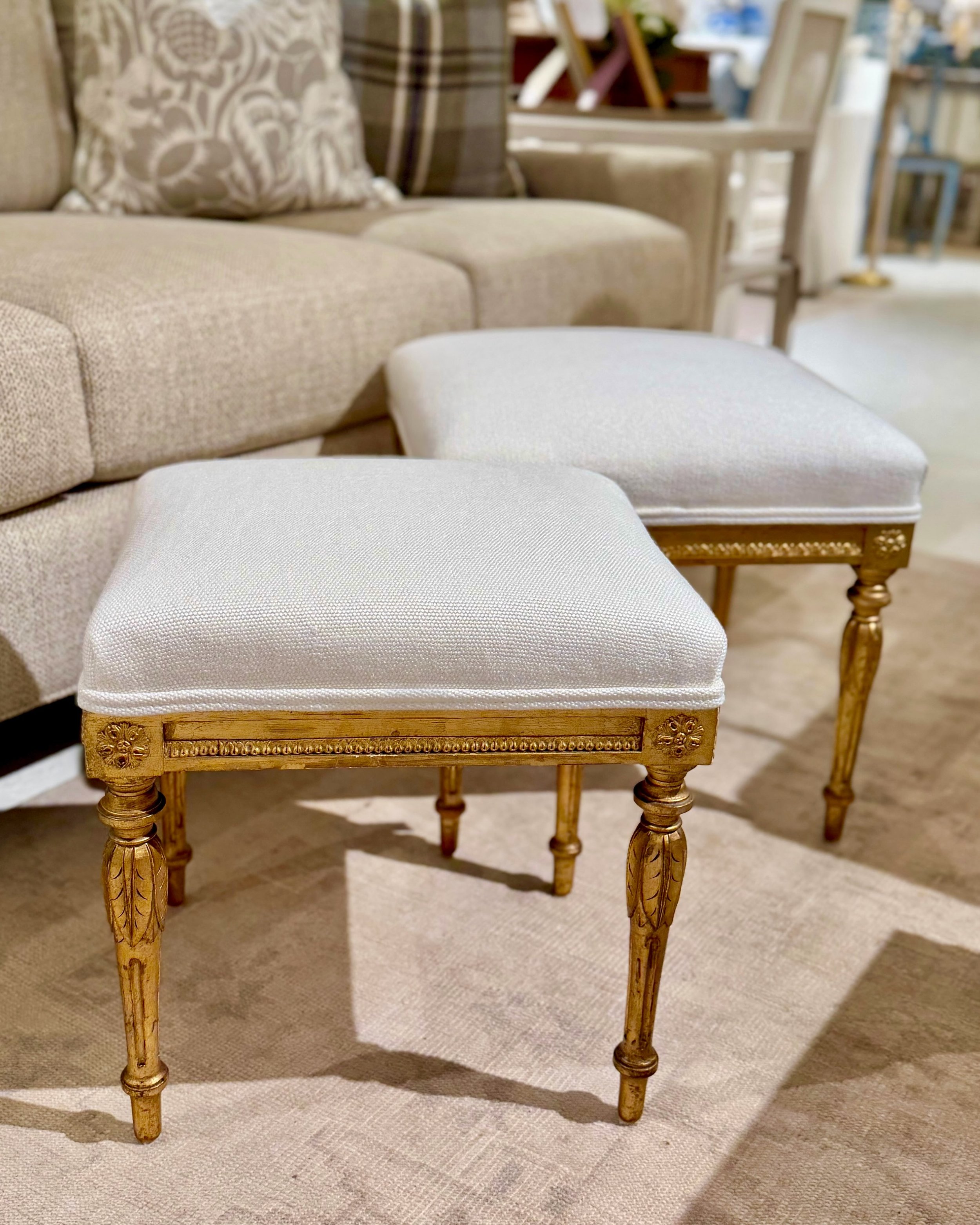 Just back from the Work Room&mdash;A Pair of Antique Gustavian Period Hand Carved Gilt Wood Foot Stools. Swedish, c.1810. New linen upholstery. Discover our extensive collection of one-of-a-kind, hand-selected European Antiques and Curated Decor. Fin