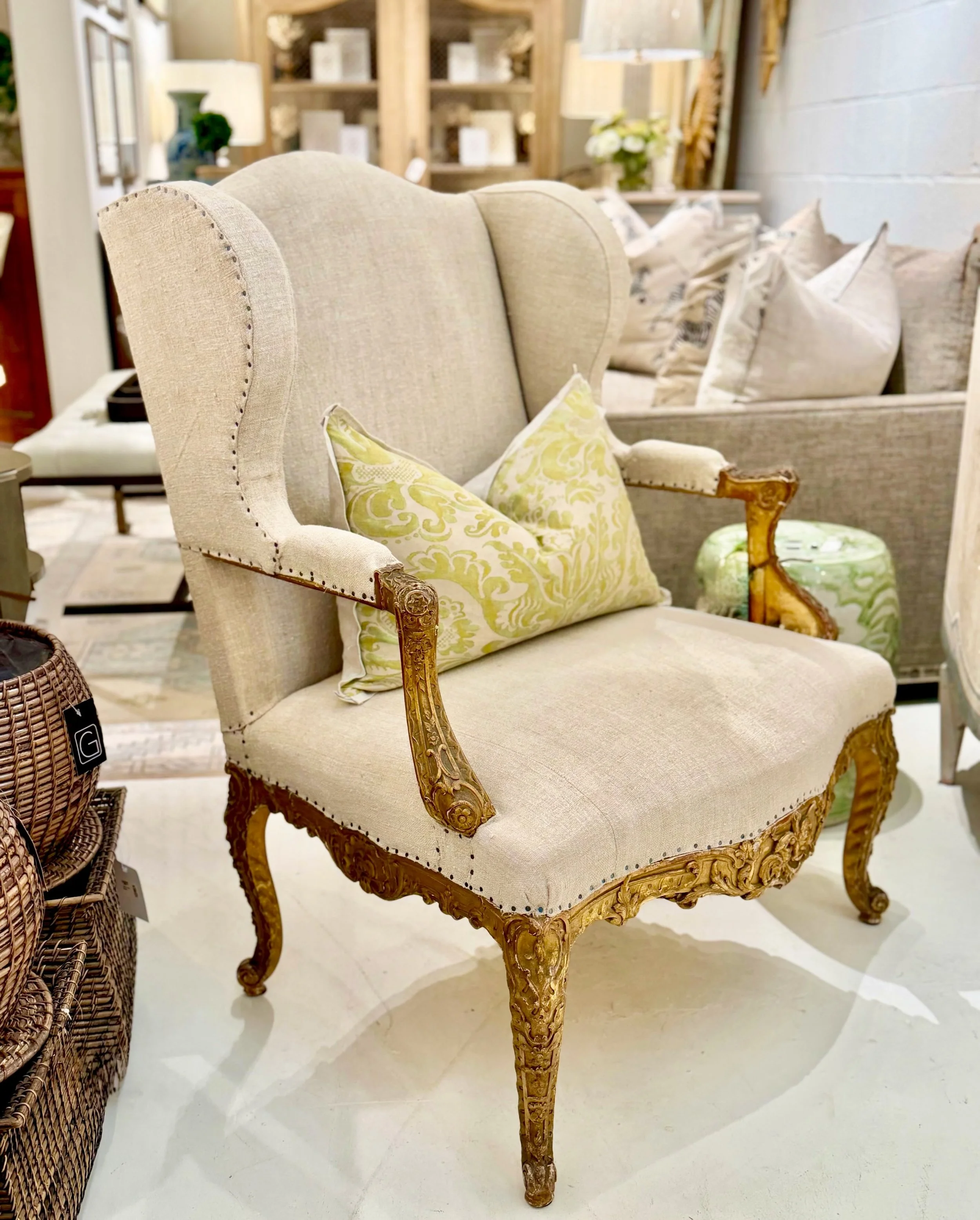 Antique Hand-Carved Gilt Wood Fauteuil. French, c.1820. Newly reupholstered in Natural Belgian Linen. Dimensions: 33.5W x 33.5D x 41.7H | 19.7SH. Discover our extensive collection of one-of-a-kind, hand-selected European Antiques and Curated Decor. F