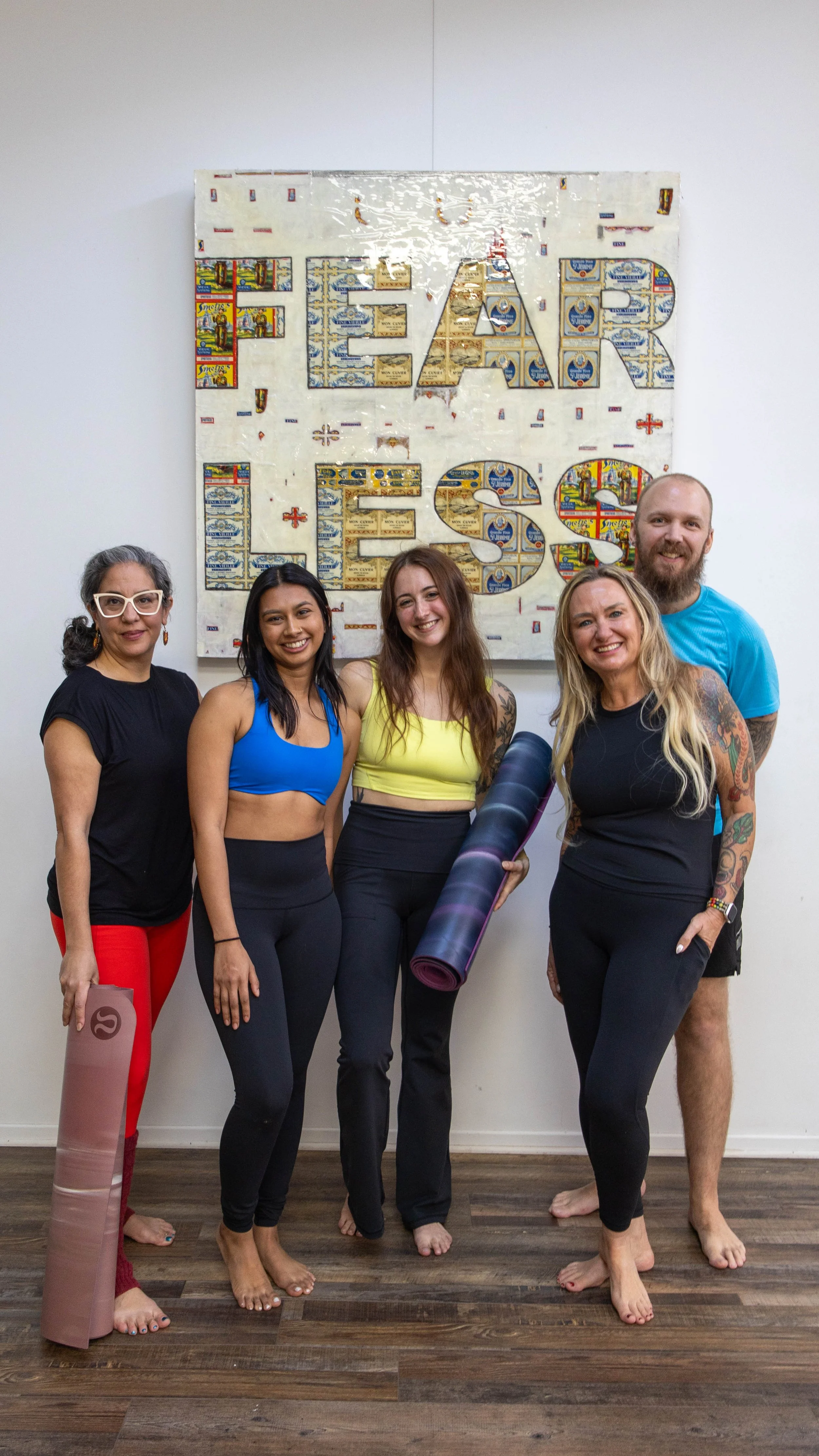 Dancing Dogs Yoga teacher training graduates in front of the FEARLESS mural in Atlanta