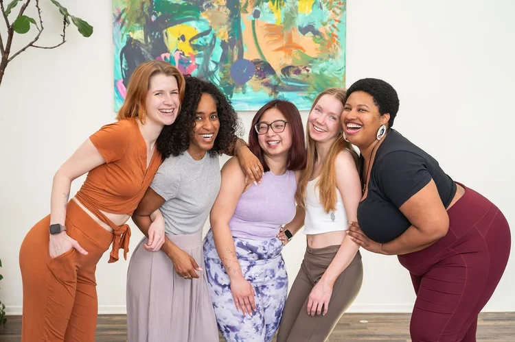 Yoga teacher trainees laughing together at Dancing Dogs Yoga in Atlanta