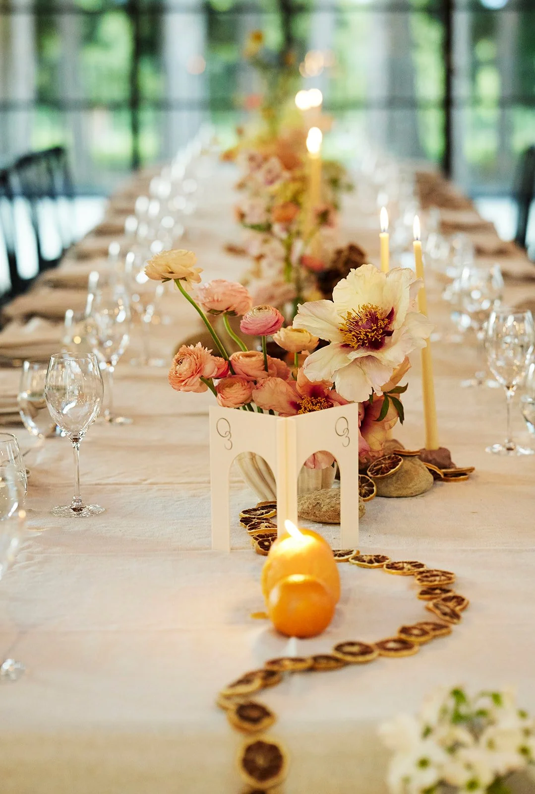 Vibrant wedding reception with fruit and bright floral arrangements