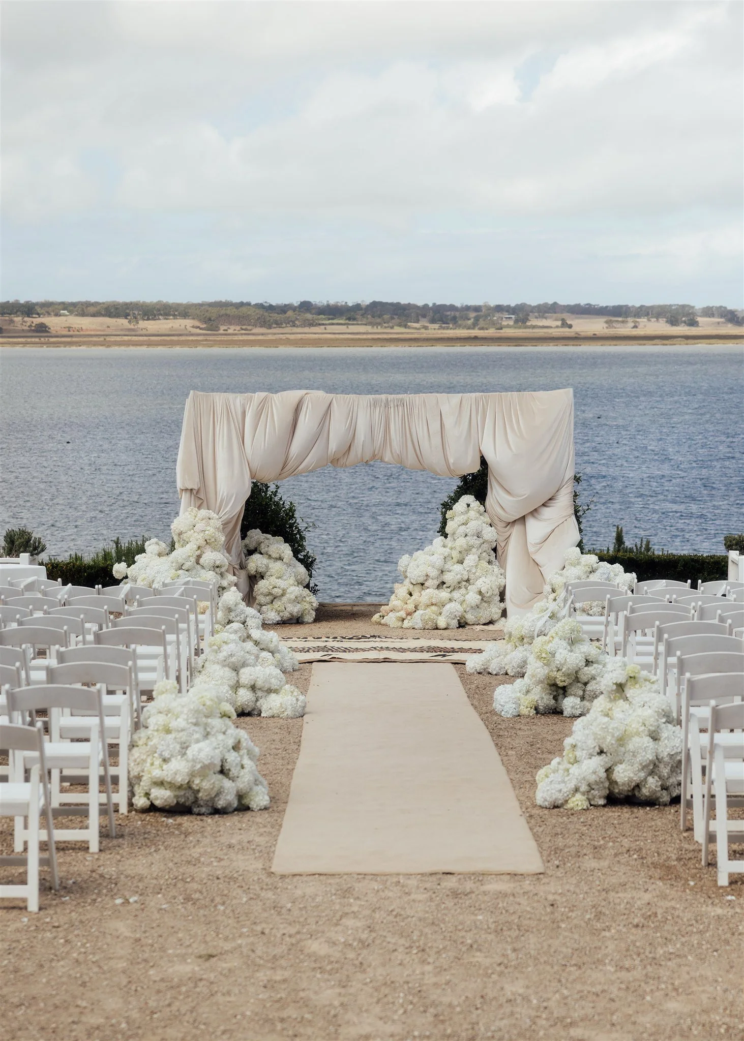 Elegant spring wedding with white floral ceremony styling