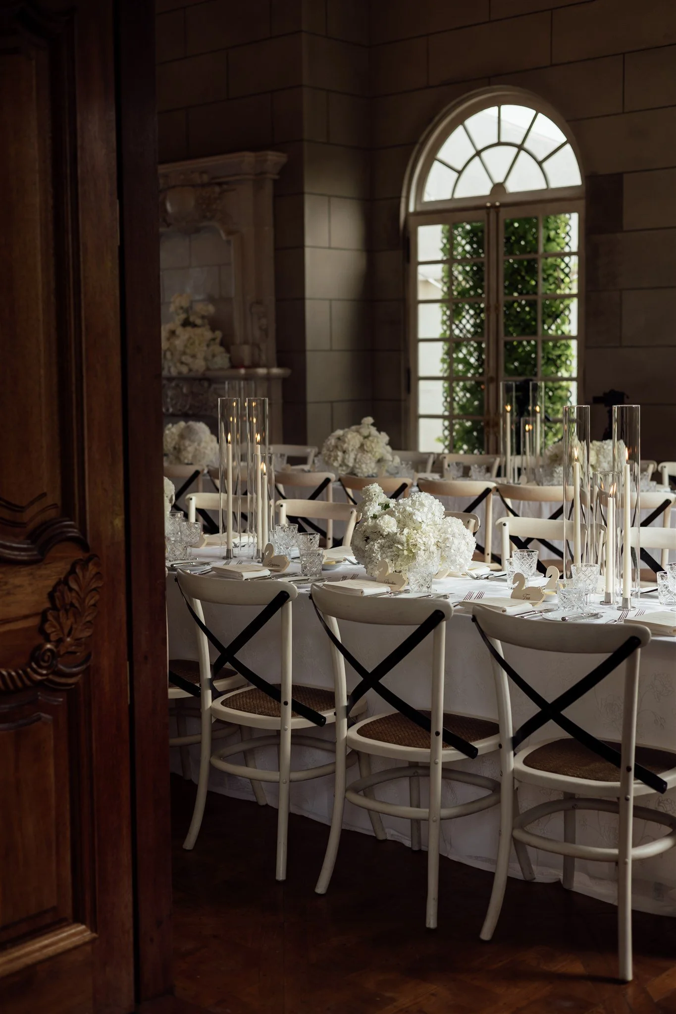 white hydrangeas, tall candles, stylish chairs and classic decor