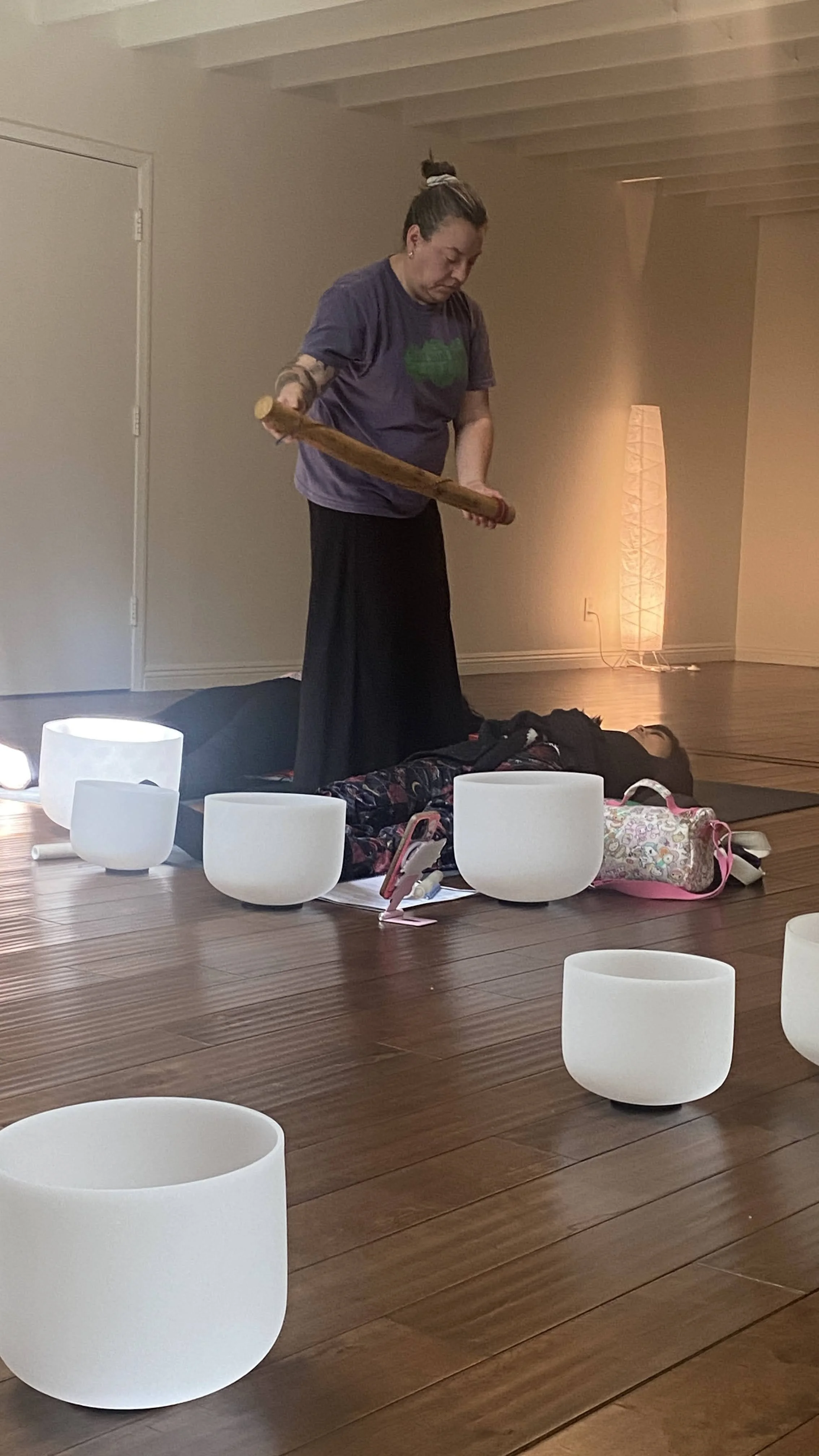 A student playing a sound healing instrument during the certification training