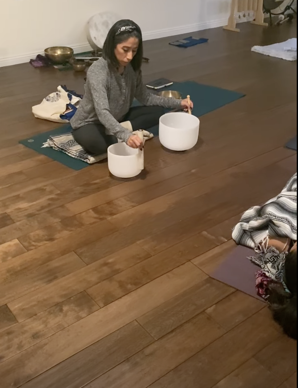 A student named Liz playing a sound healing instrument during the certification training at The Mystic Living School