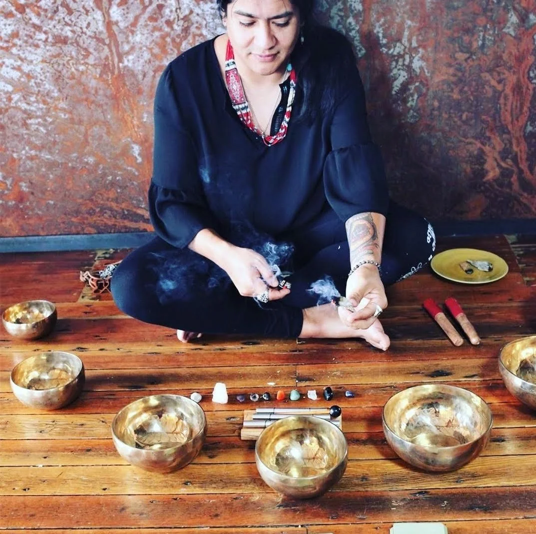 Students practicing with sound healing instruments in a group setting during the certification training