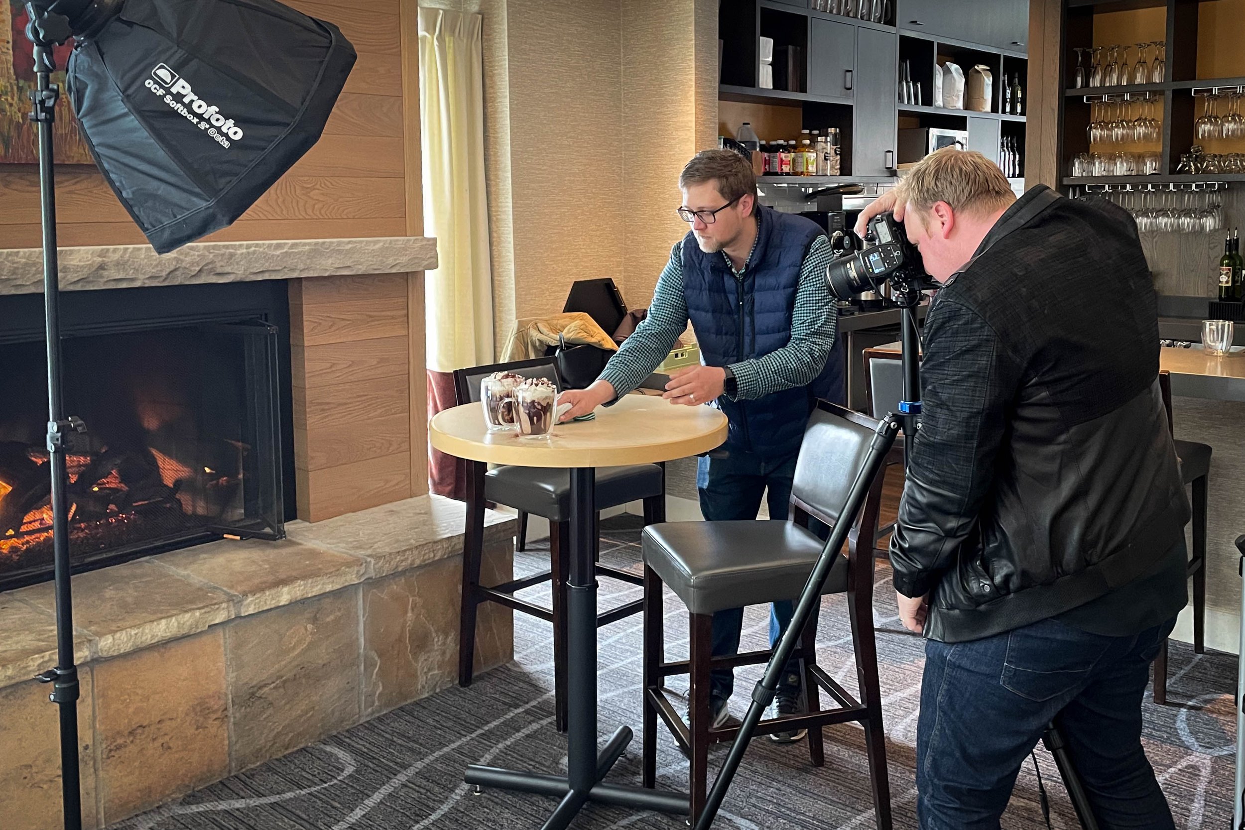 Behind-the-scenes view of a resort photographer using professional lighting and camera equipment during a hospitality shoot