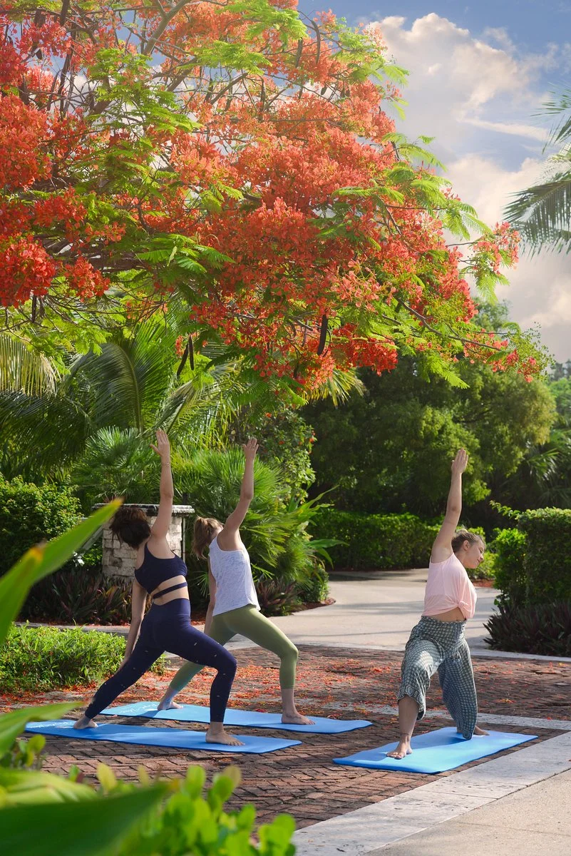 Guests participating in an outdoor yoga class at a resort, demonstrating lifestyle photography that highlights wellness and guest experiences.