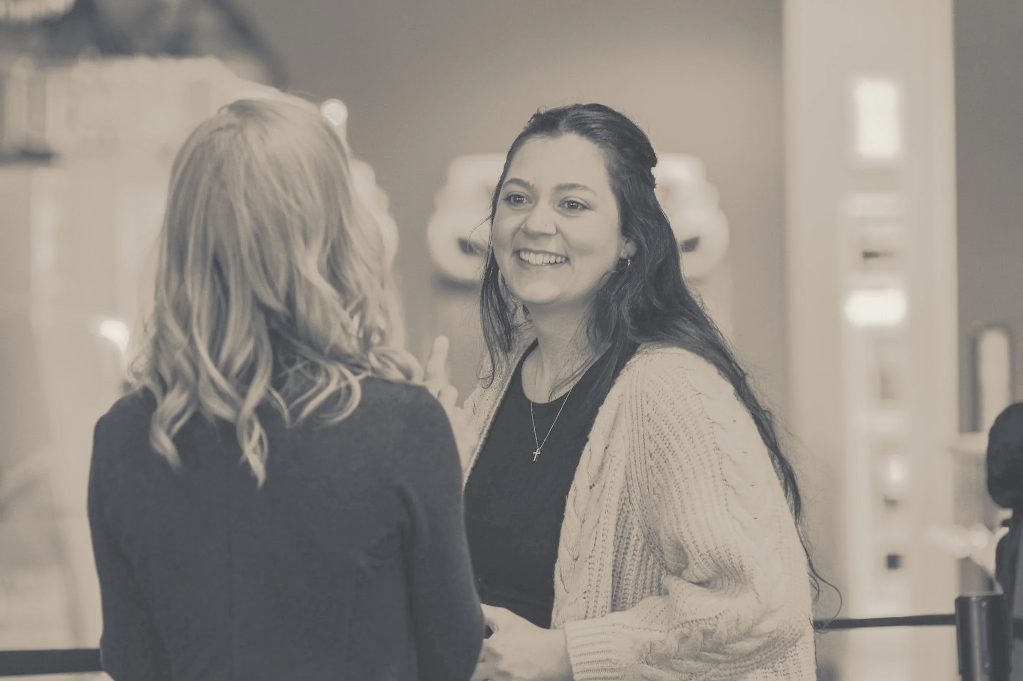 two women talking in church lobby