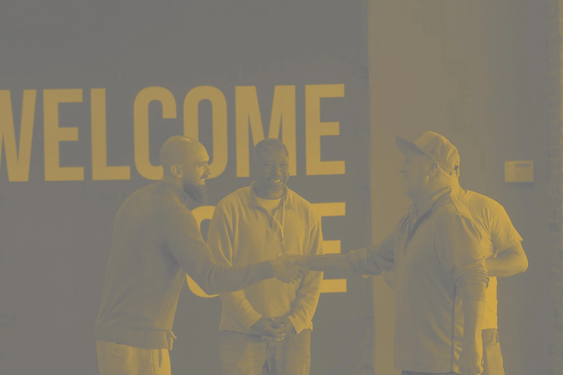 pastor greeting people at the front door