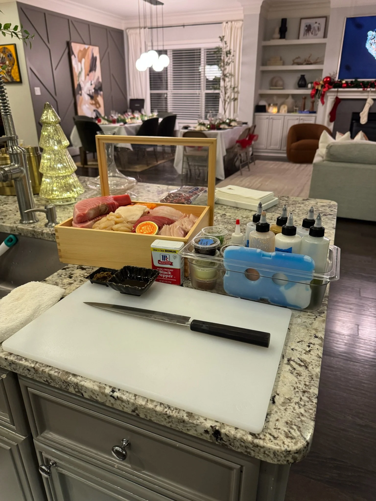 Ingredients and knives set up on a kitchen counter in preparation for an omakase experience