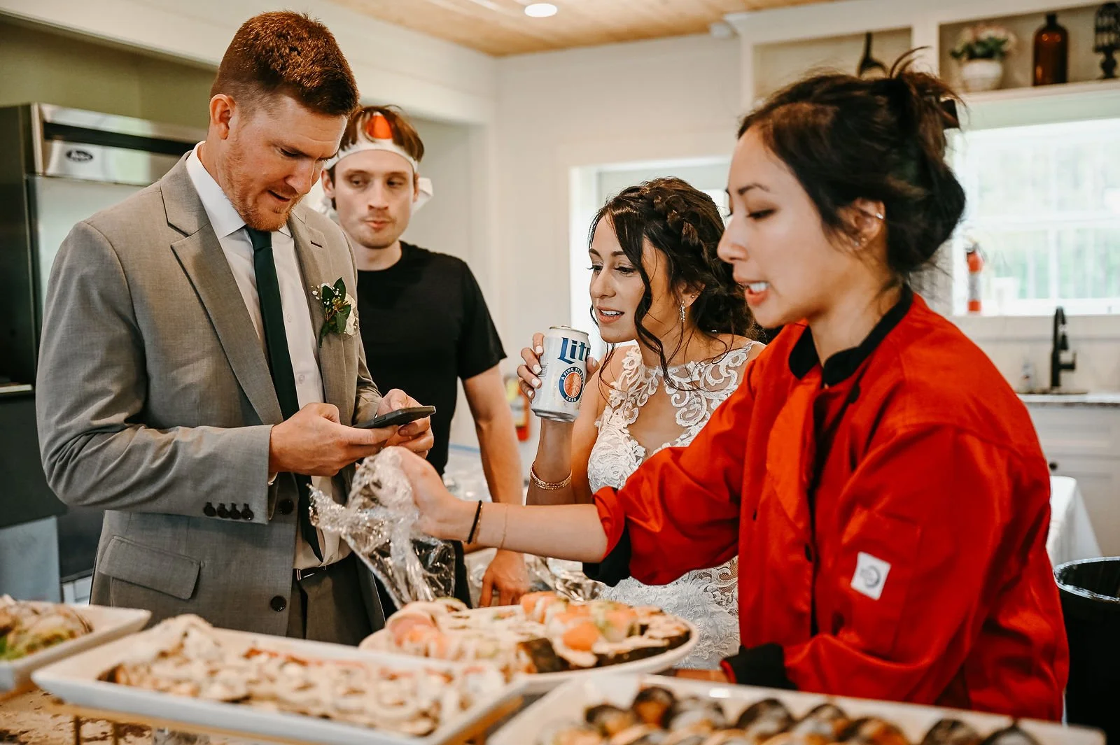 A wedding couple being served sushi by a LAV Sushi chef at their reception