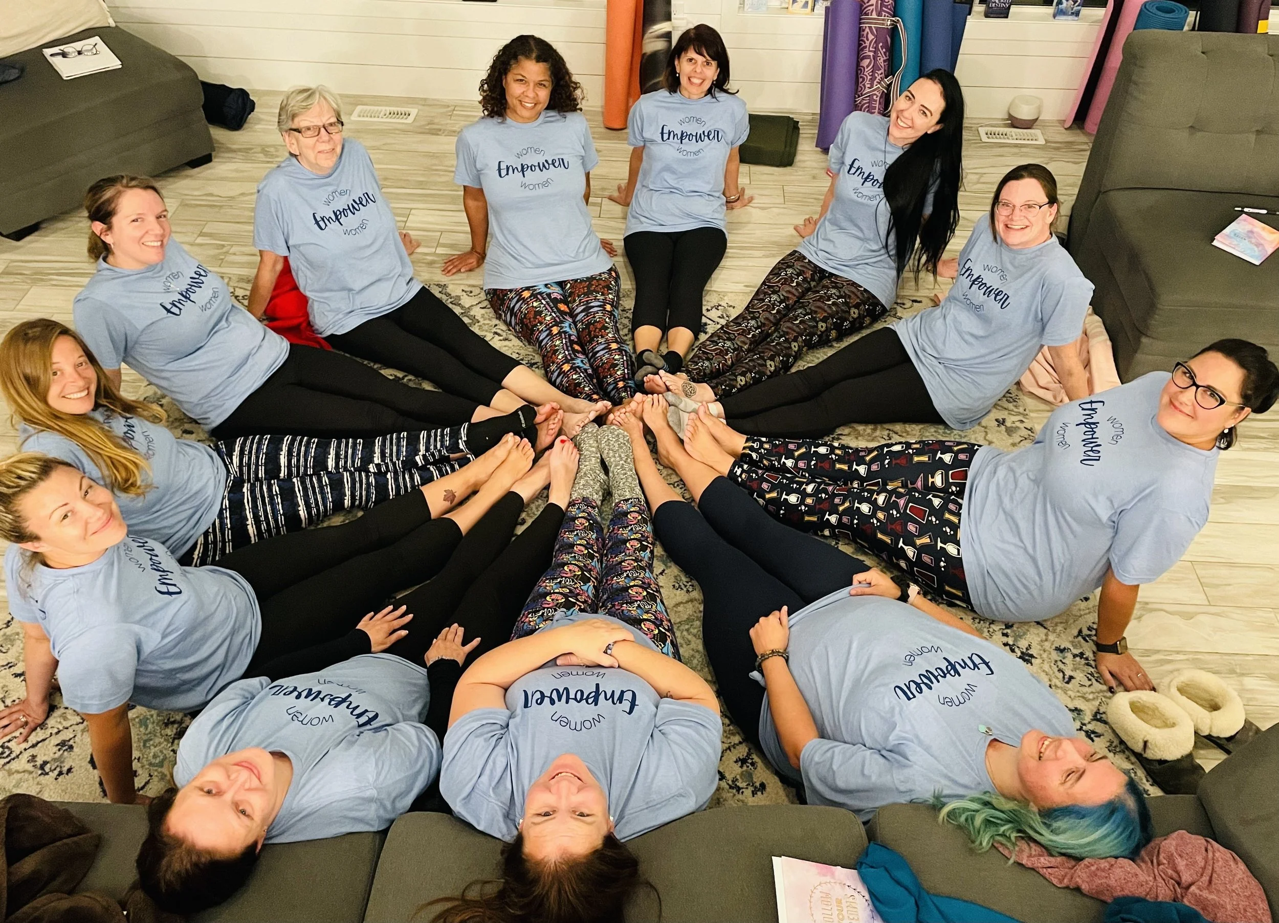 Group of women sitting in a circle wearing matching ‘Empowered Women’ shirts at the Release Retreat hosted by Chivonne Monaghan