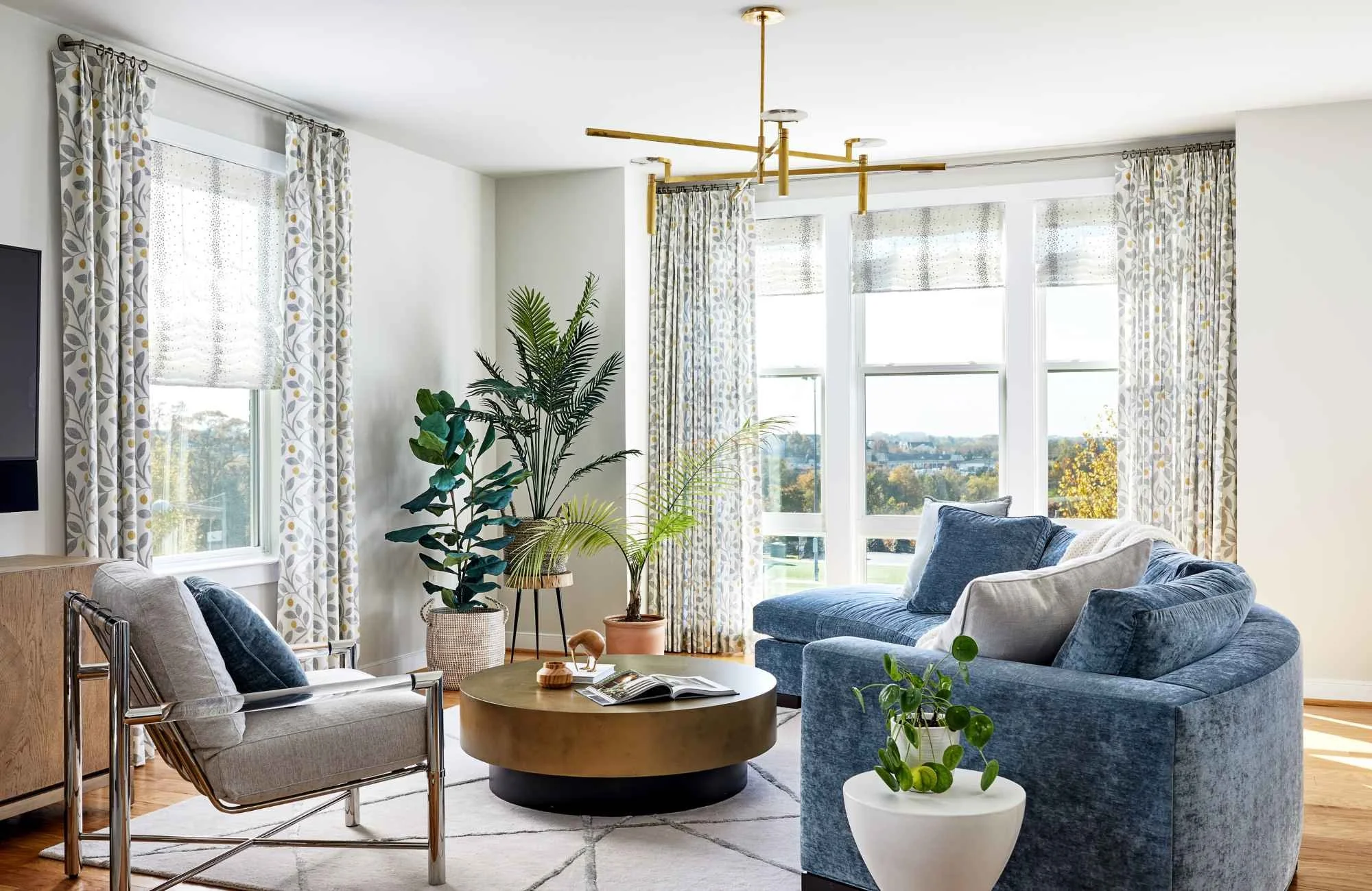 christie-leu-interiors-bethesda-md-scale-and-proportion-classic-living-room-curved-blue-sofa-large-windows-natural-light-elegant-interior-design.jpg