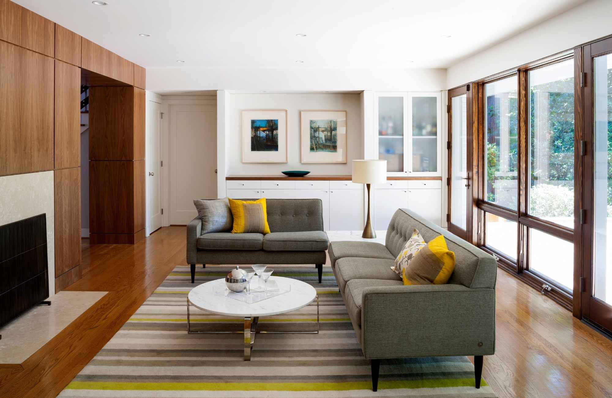 full-service-interior-design-herndon-park-va-scale-and-proportion-mid-century-modern-living-room-wood-wall-gray-sofas-large-windows-minimalist-contemporary.jpg