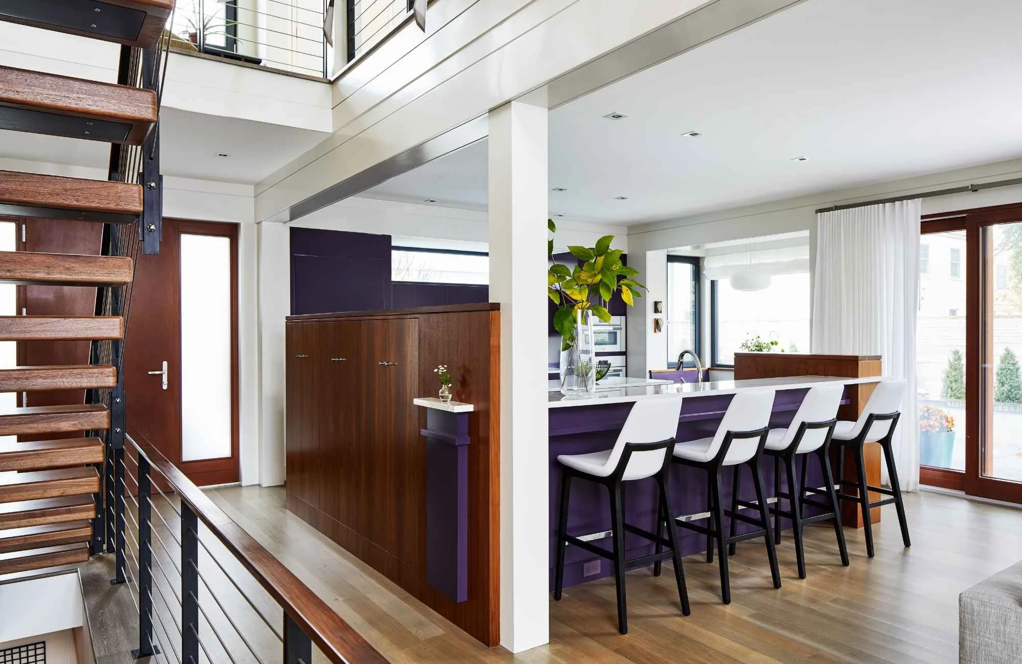 christie-leu-interiors-montgomery-county-md-wood-accents-in-home-contemporary-home-view-into-kitchen-from-hallway-dark-stained-wood-elements-efficient.jpg