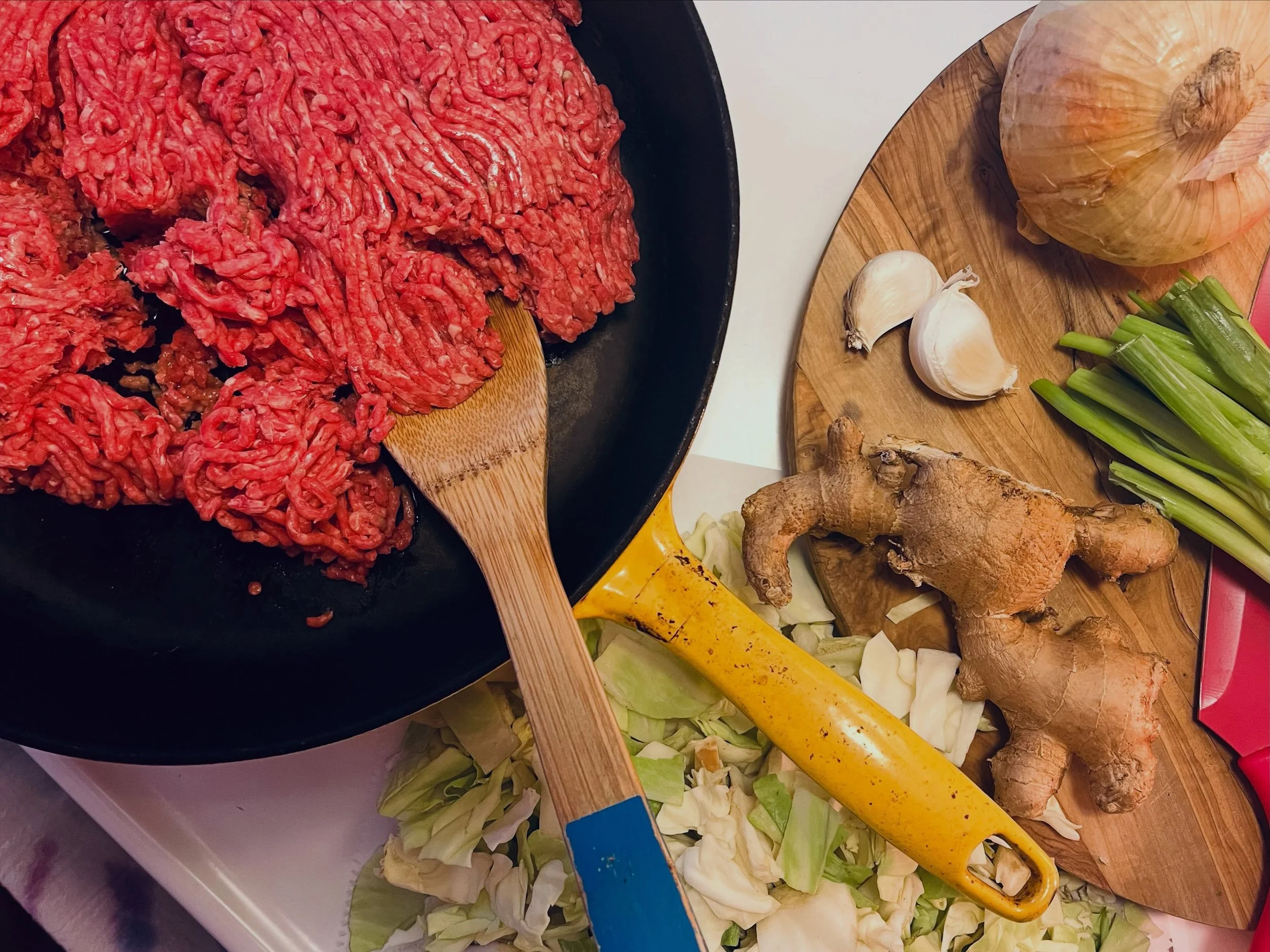 throwing together
another meat+ meal&mdash;
let's call this one: ginger beef bowl.
'using up my fresh ingredients
in an act of stewardship&mdash;
green cabbage, garlic, green onion,
sweet onion, + fresh ginger root.
.
starting by crisping the 2lbs
of