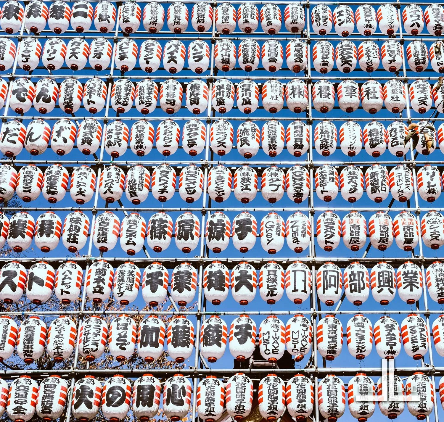 Rows of traditional Japanese paper lanterns with kanji characters