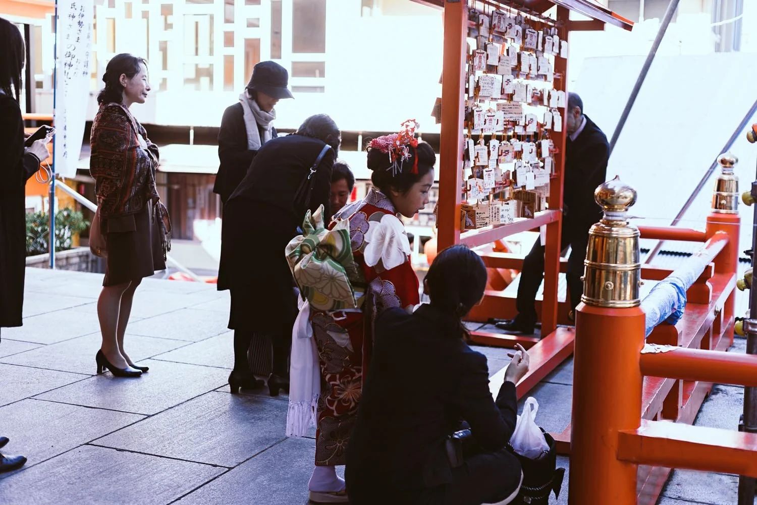 People visiting a Japanese shrine with ema boards