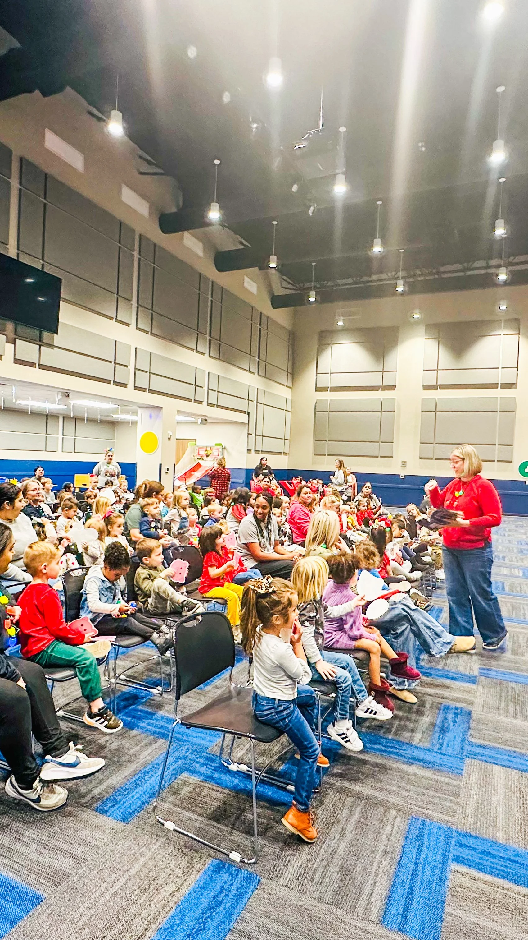 Group of children sitting and listening to Amanda, the author of Rowe+Rinn Books, speaking in a classroom setting.
