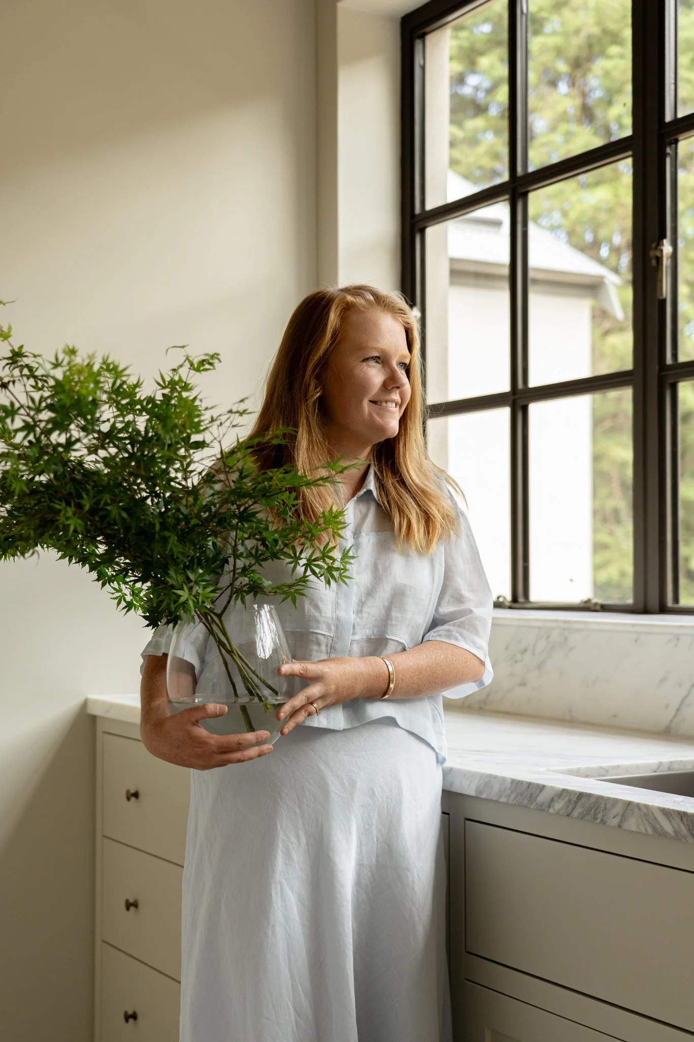 Alex Harrington, residential architect and founder of Studio Harrington, photographed in a light-filled kitchen interior