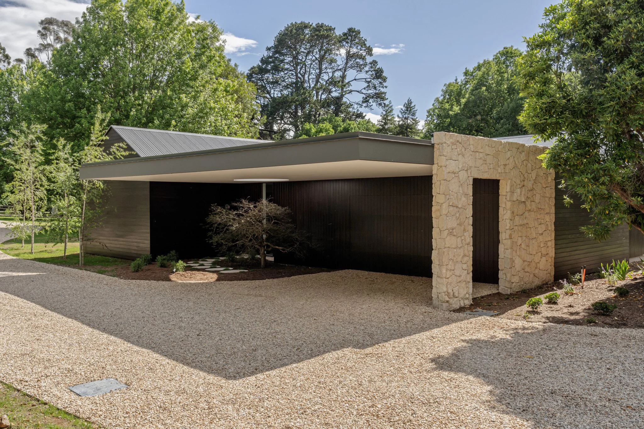 Contemporary country home arrival pavilion with stone columns and dark timber cladding, Southern Highlands architect Studio Harrington