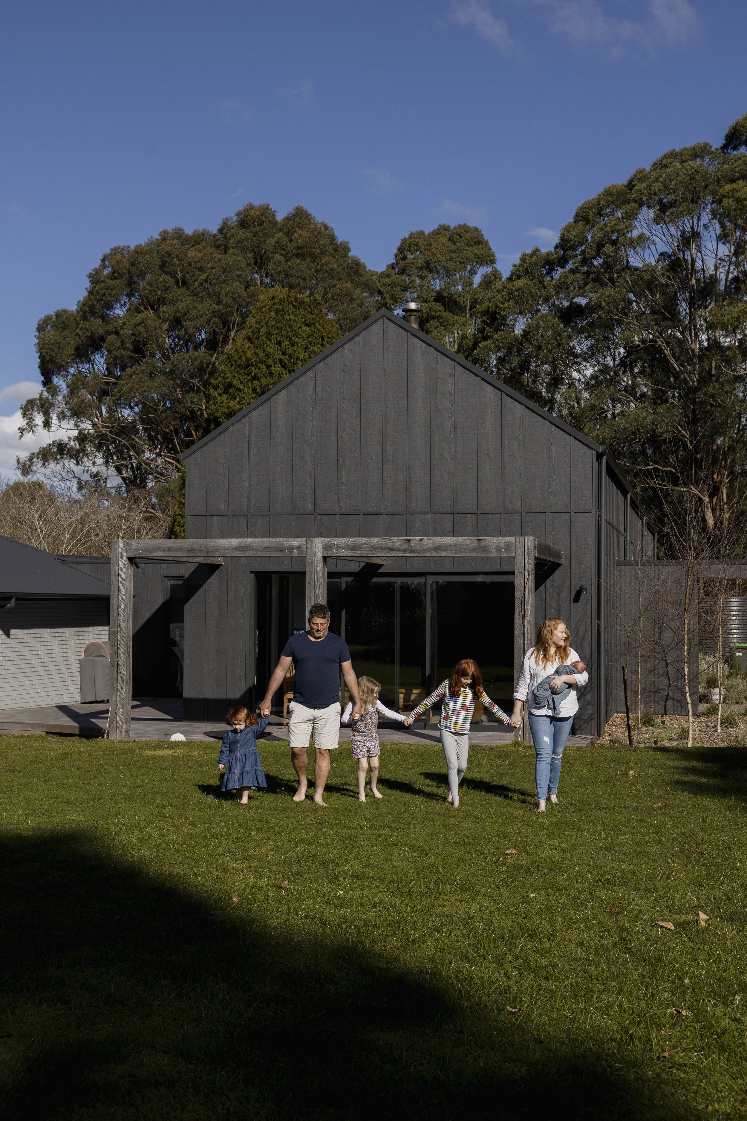Family enjoying outdoor space at The Shed, the architect’s own home in Robertson NSW