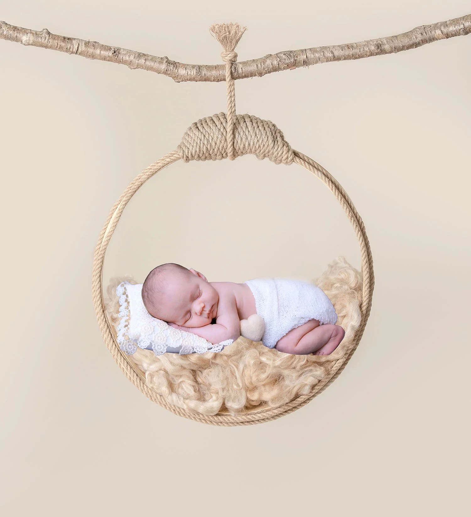 Newborn baby peacefully sleeping in a circular macrame swing, resting on a plush fur blanket. Creative and ethereal newborn photography in Lancaster, PA.