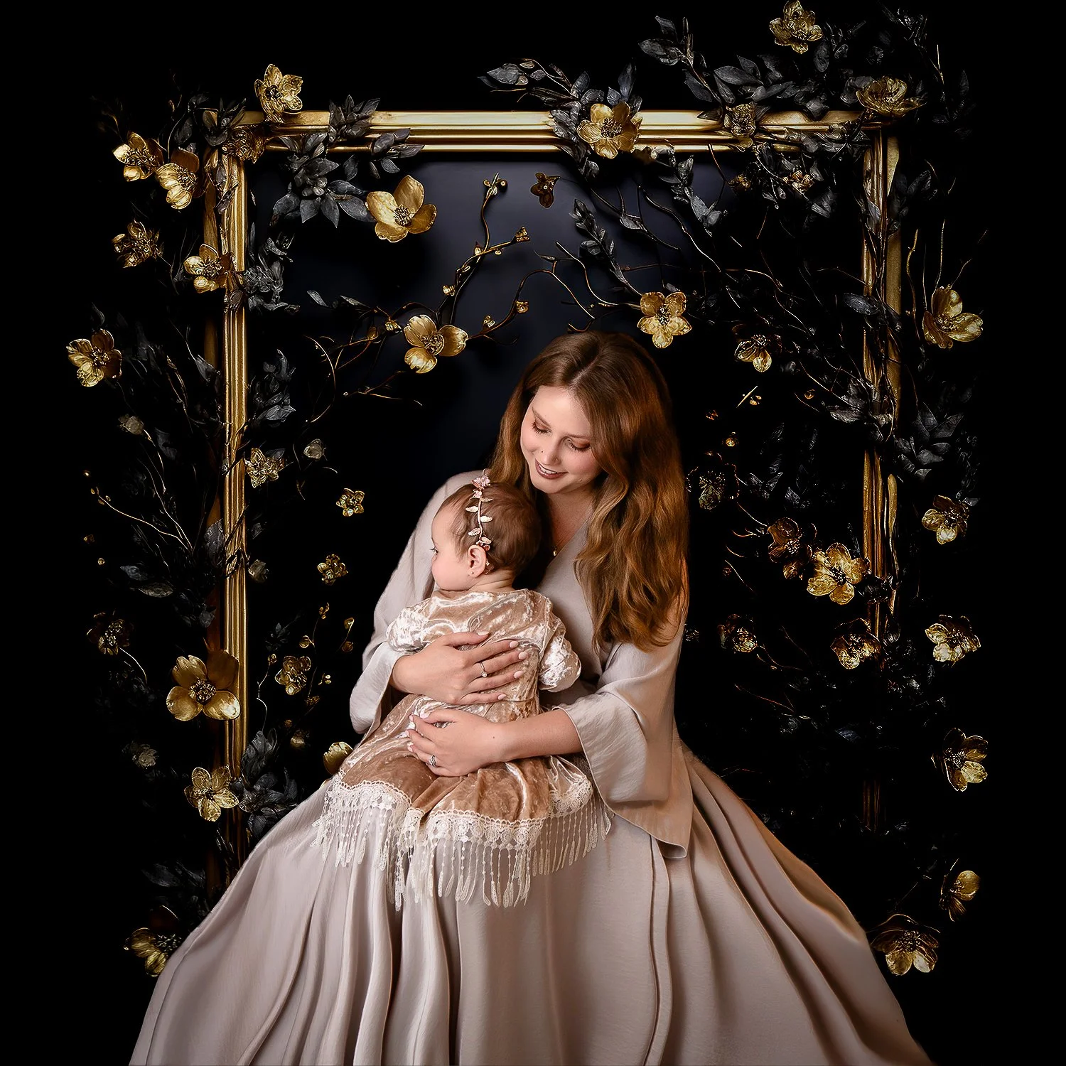 mother and daughter wearing cream colored dresses with gold frame with gold flowers