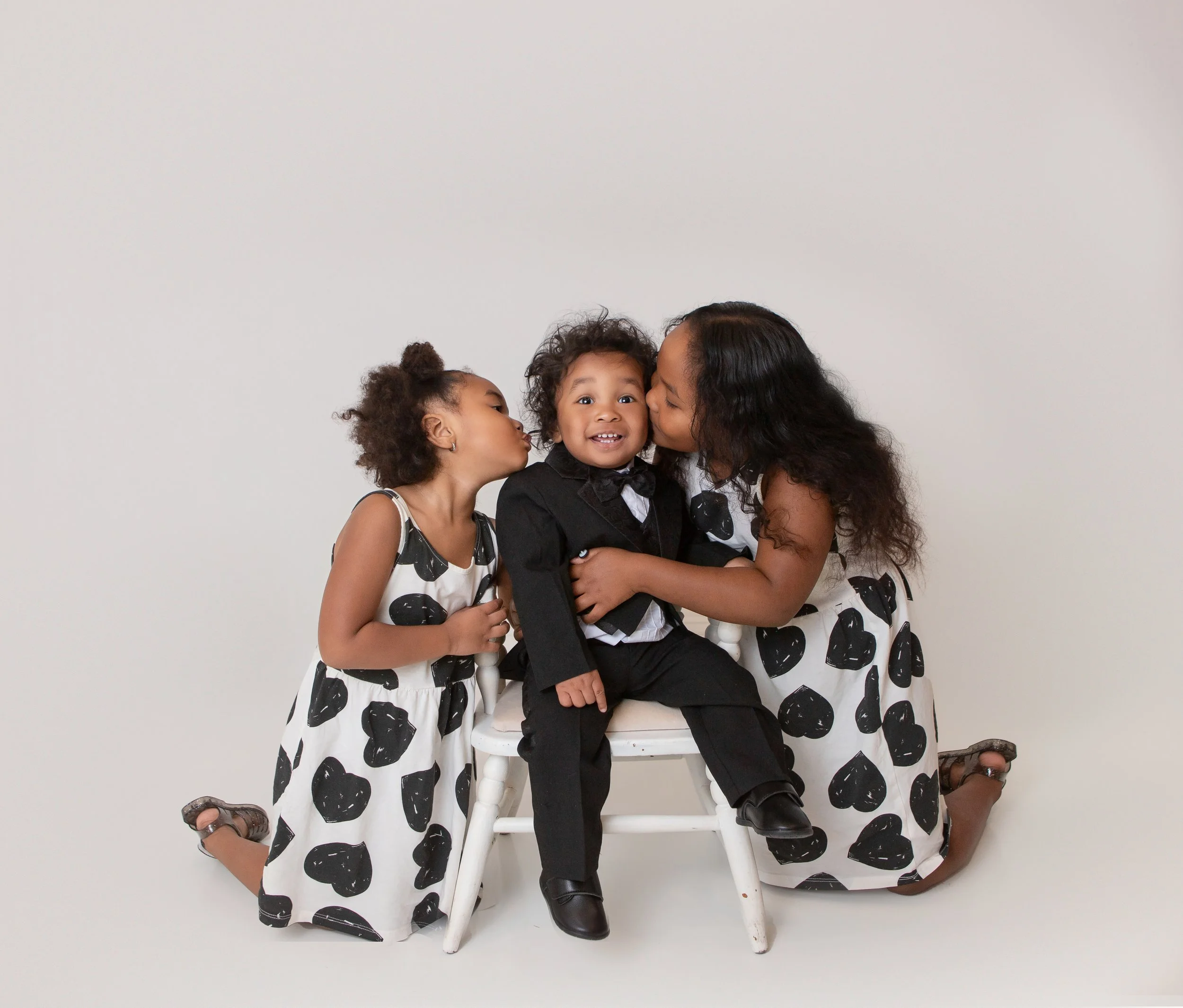 three children dressed in black and white