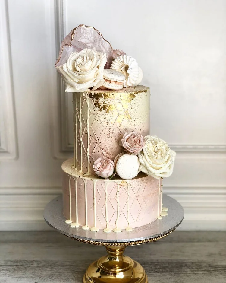 Laurie’s customers, Mariana and Carmen holding hands on a green lawn on their wedding day.
