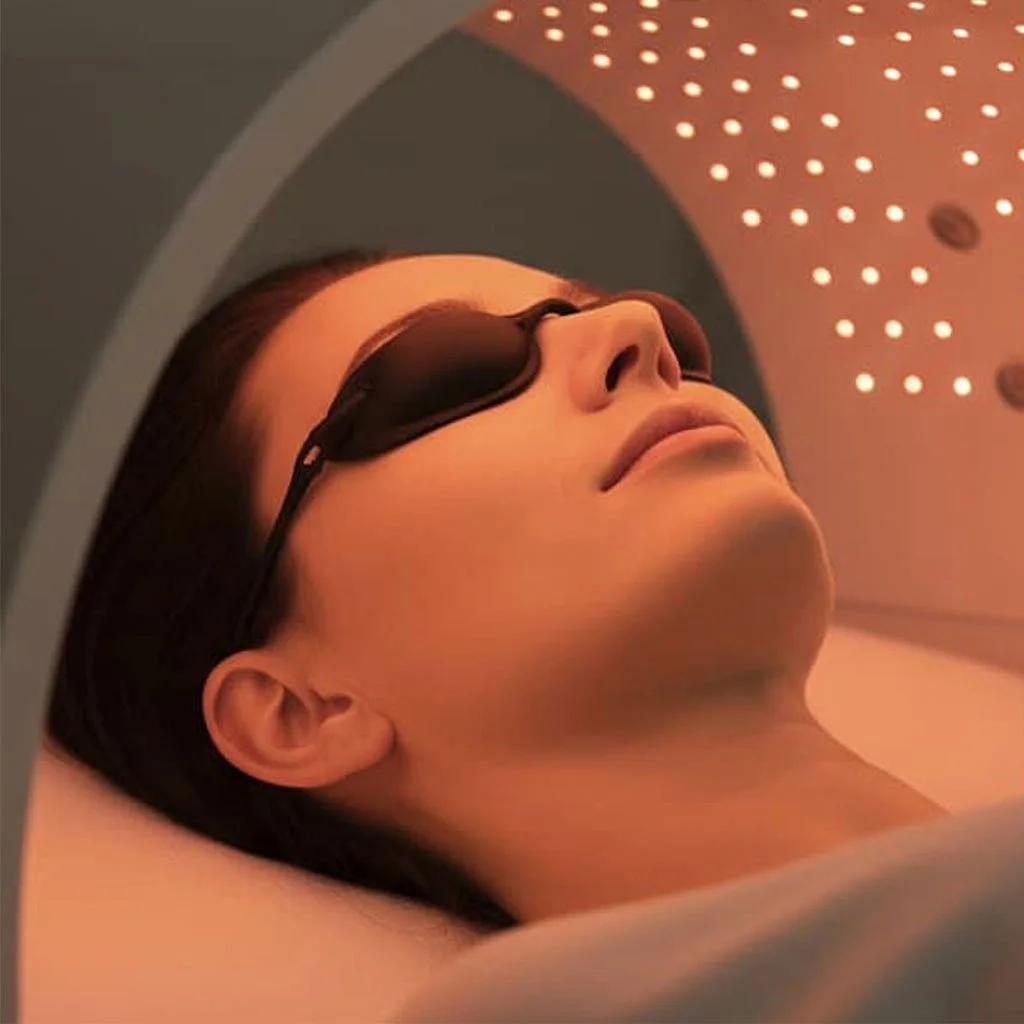 Woman receiving Dermalux light therapy on face