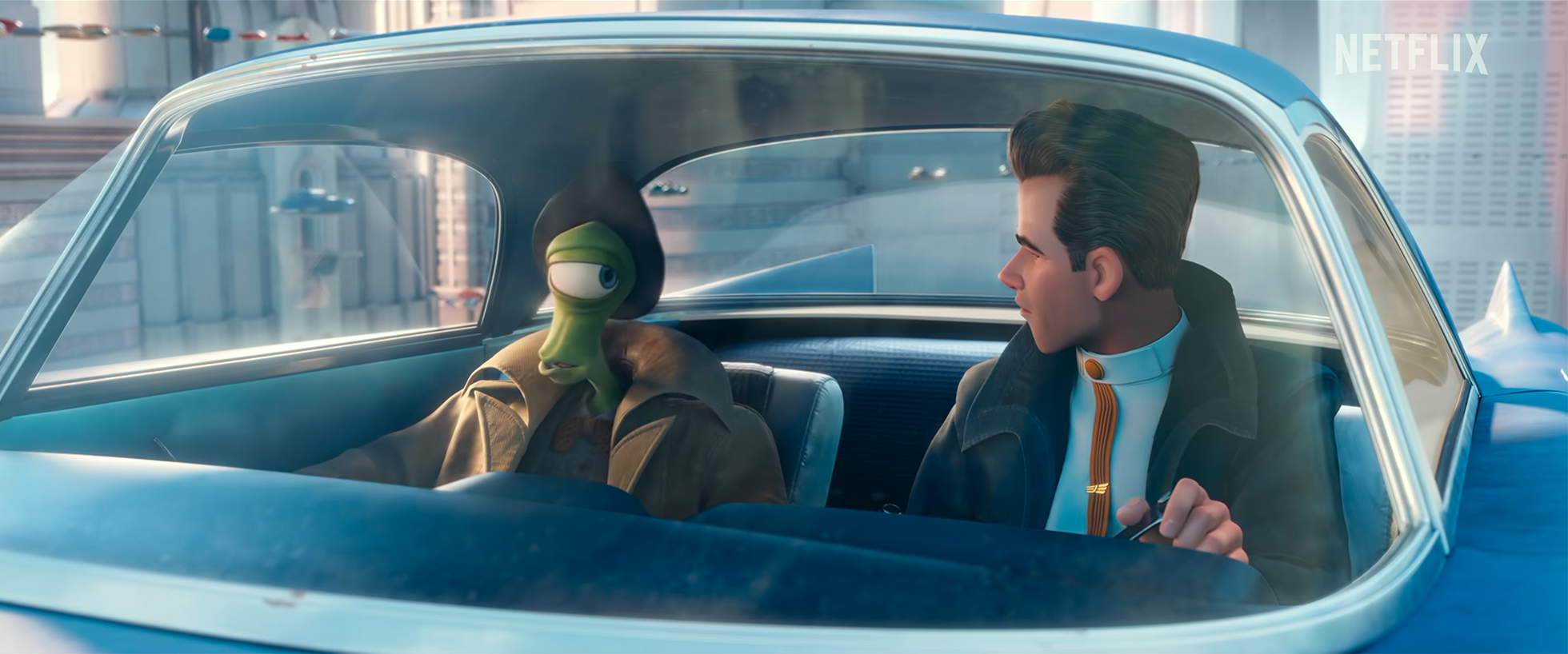 Two animated characters sitting in a car, with one appearing to be an alien with green skin and one a human male, in a cityscape background.